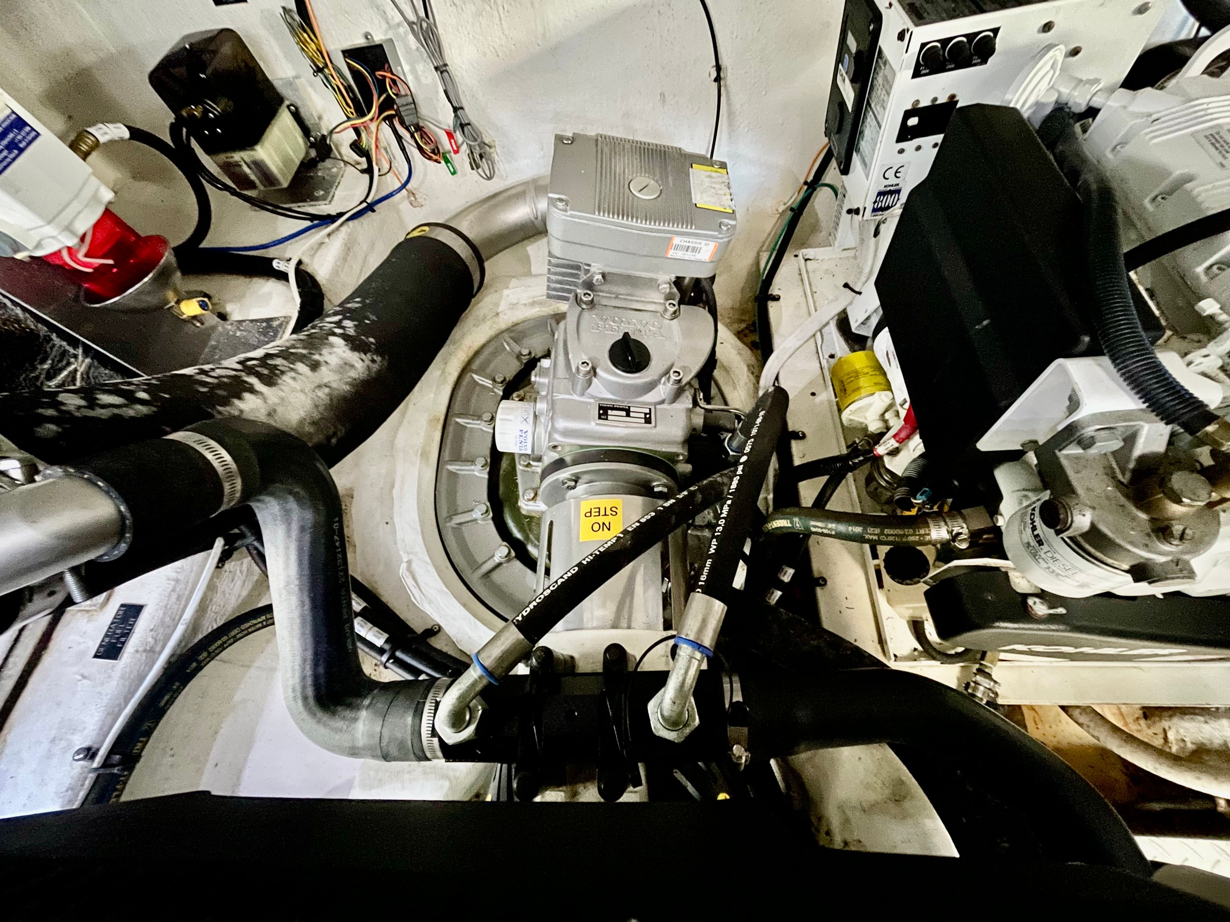 The engine room of a 2016 Cruisers Yachts 390 Express Coupe shows engines and hoses.