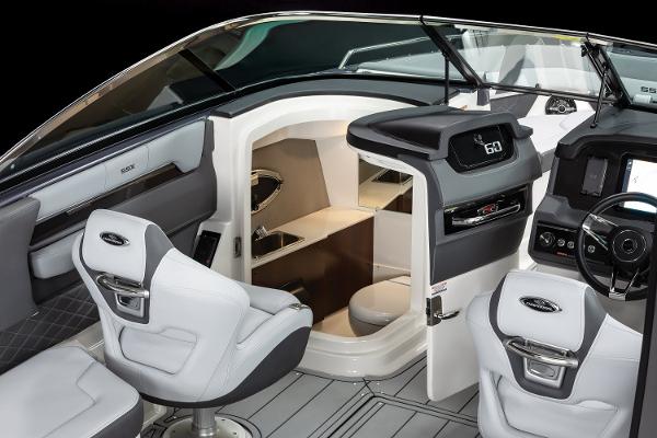 Interior of 2025 Chaparral 2870 boat, featuring modern helm and seating area.