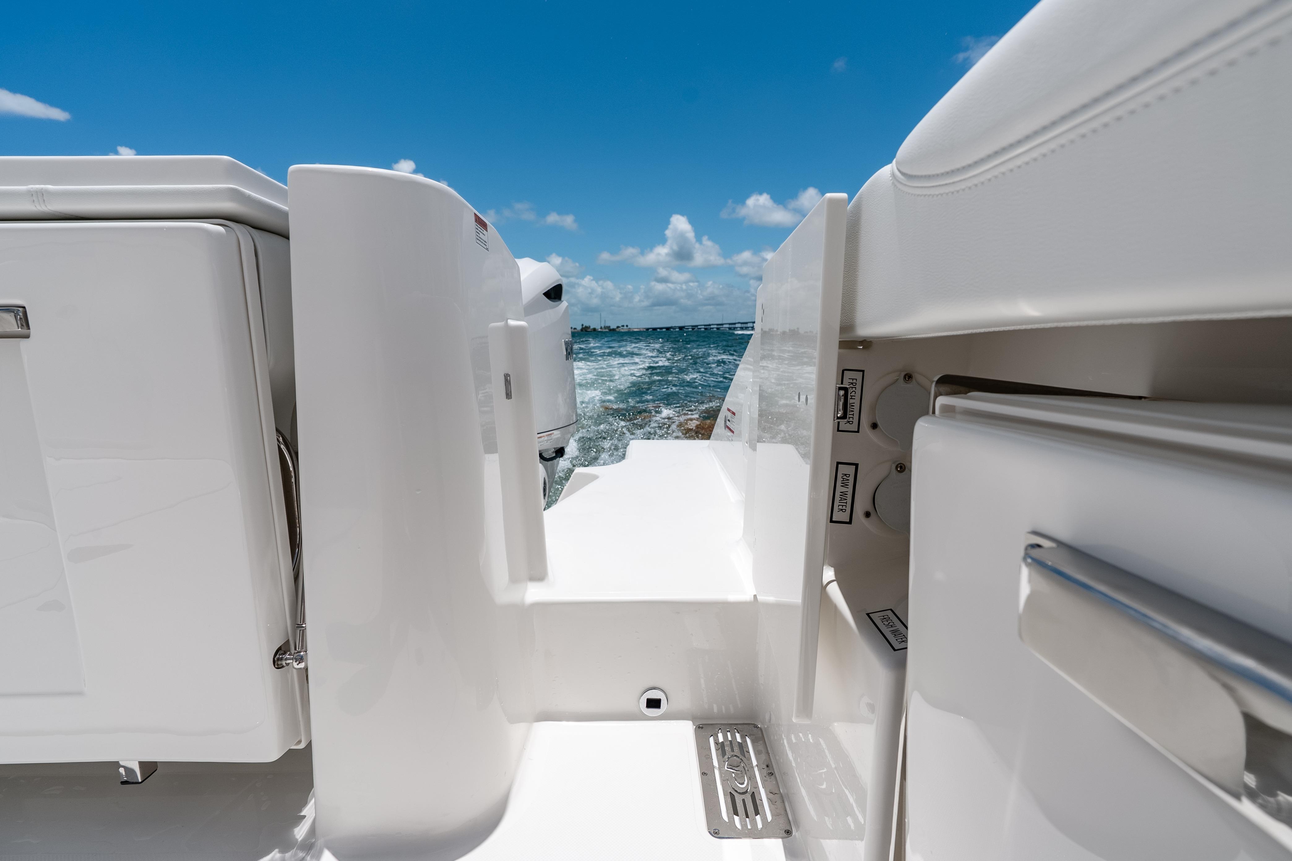 2026 Pursuit DC 326 Dual Console boat deck with ocean view under clear blue sky.