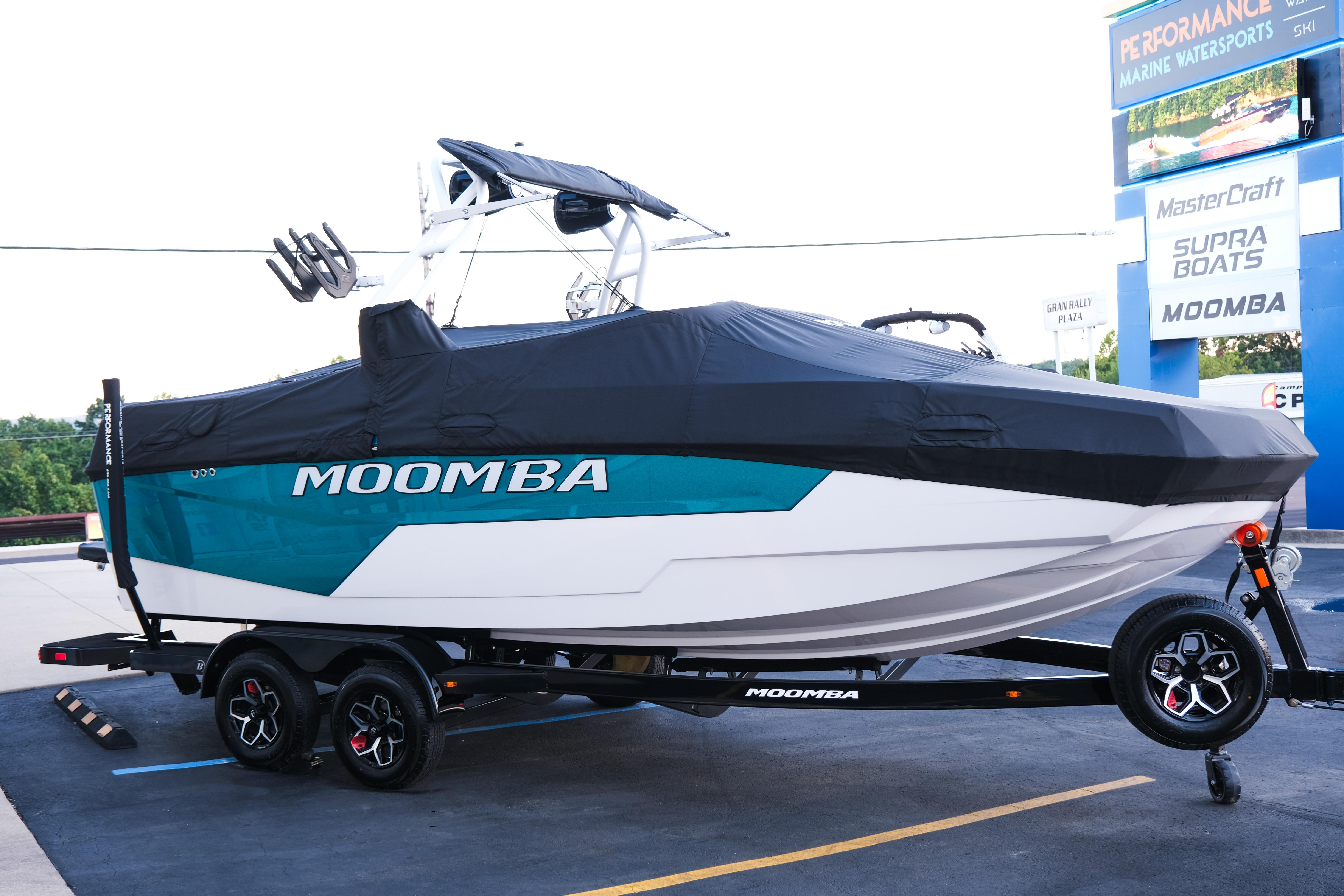 2026 Moomba Max boat on trailer, covered, at a marine dealership.