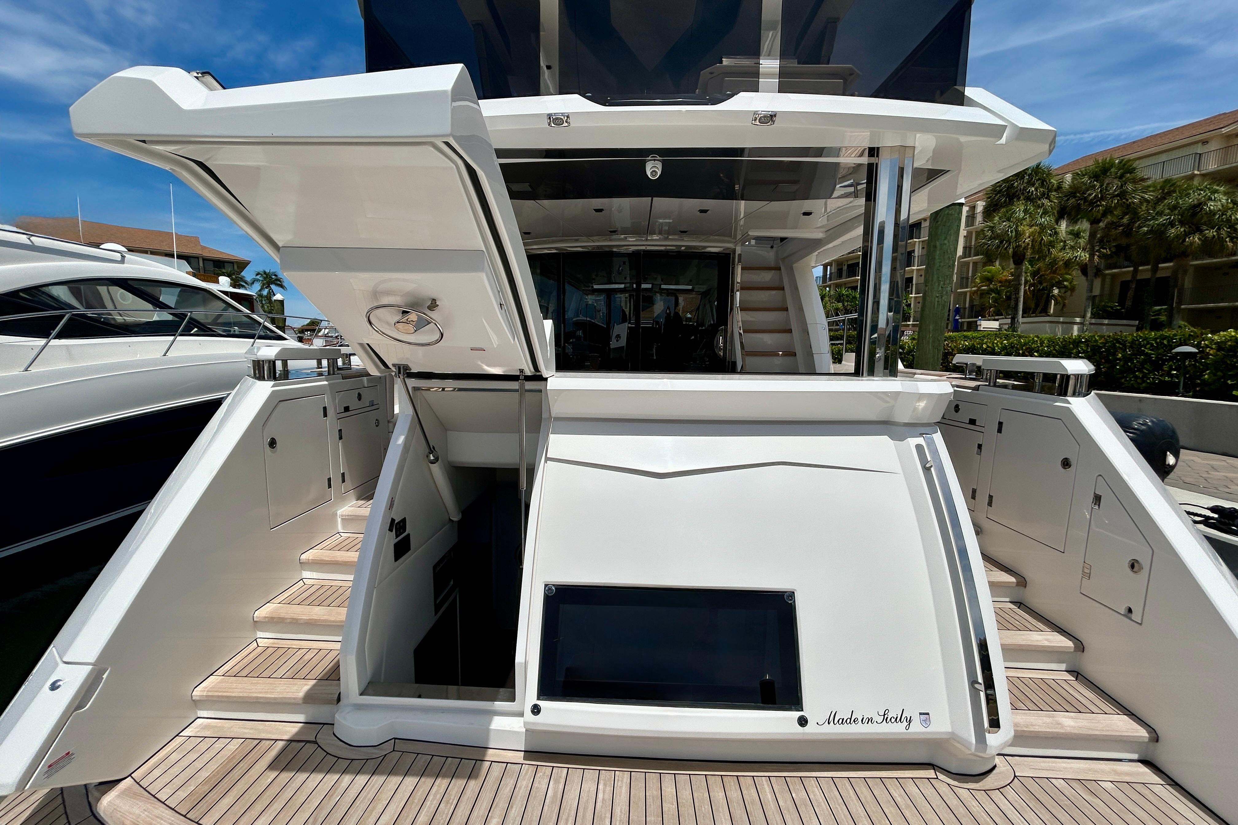2024 Aicon Vivere 66 yacht stern view with open hatch and teak deck.