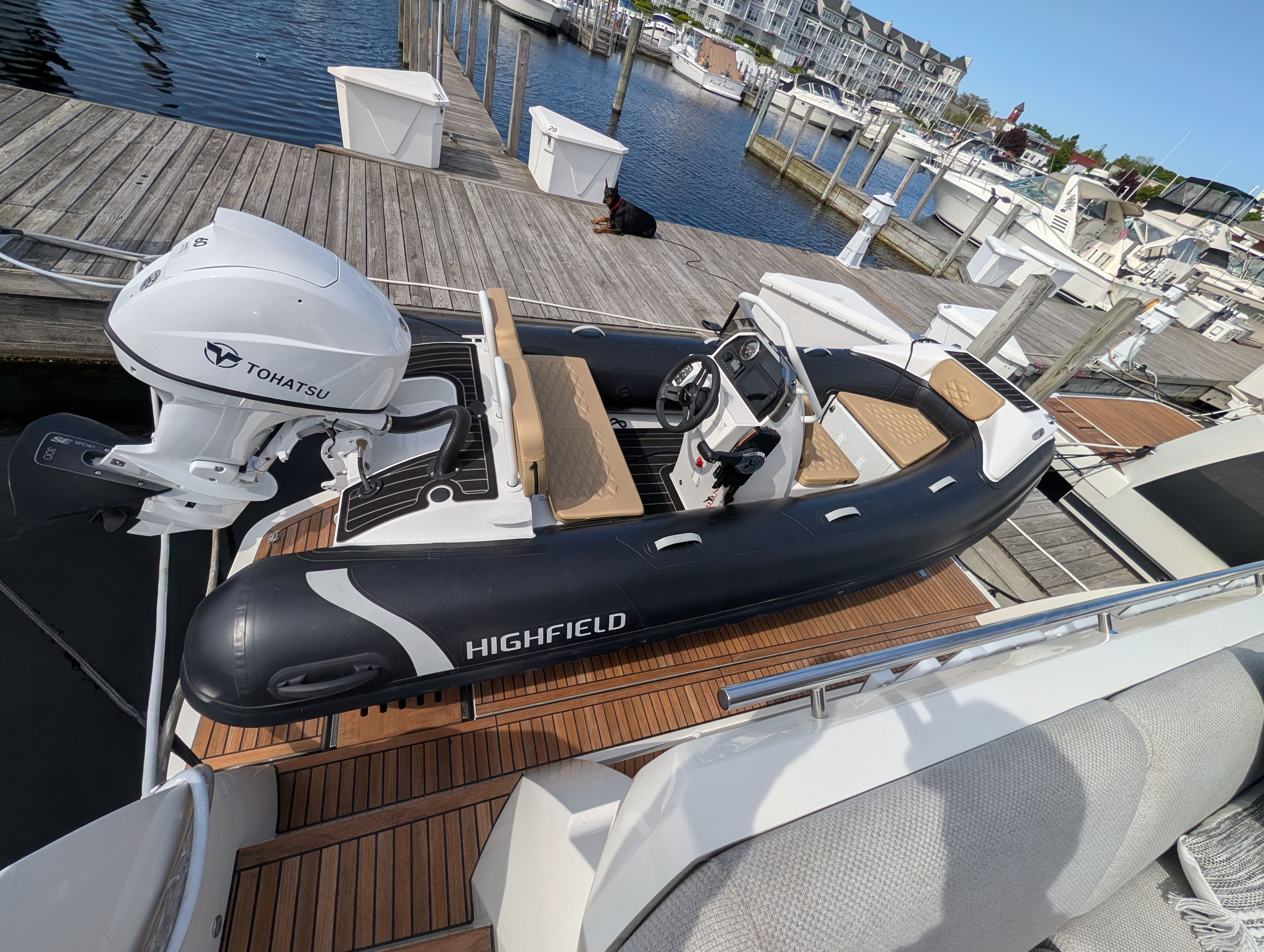 2024 Highfield Sport 390 inflatable boat docked with Tohatsu engine.