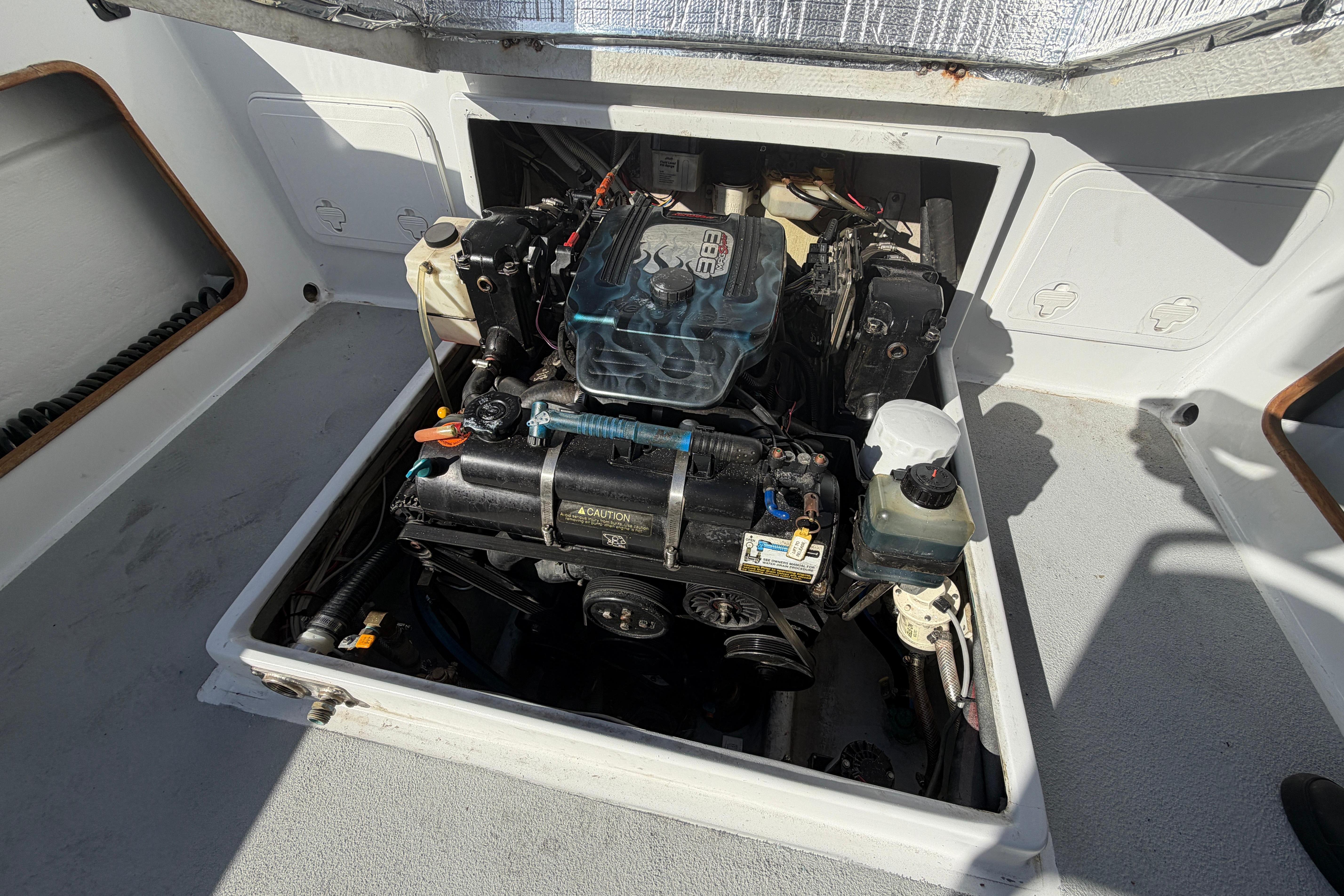 Engine compartment of a 1986 Radon 21 Sport boat, showcasing detailed mechanical components.