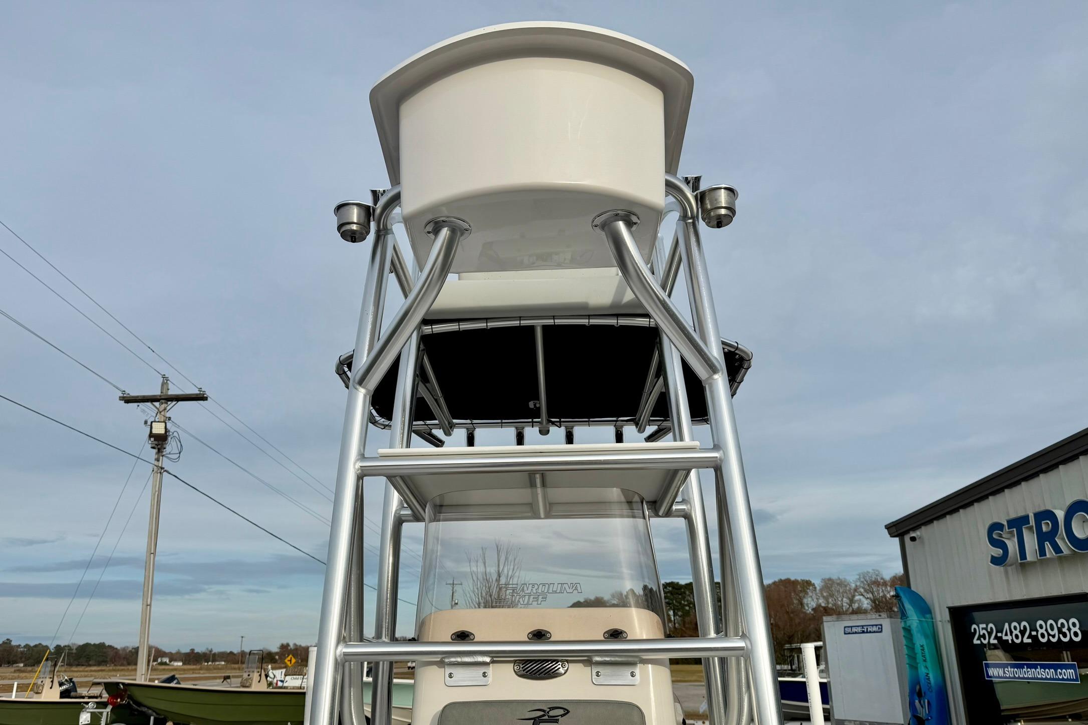 2025 Carolina Skiff 21 LS boat with T-top and sturdy metal framework.