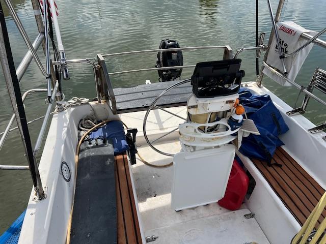 1999 Contour 34 SC sailboat cockpit with steering wheel and seating.