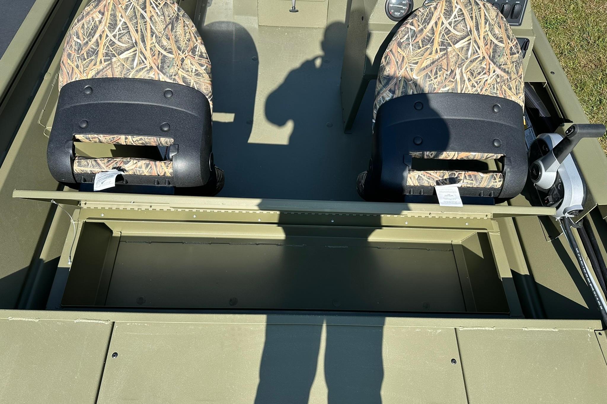 2026 Lowe Roughneck 1860SC boat interior with camo seats and storage compartment.