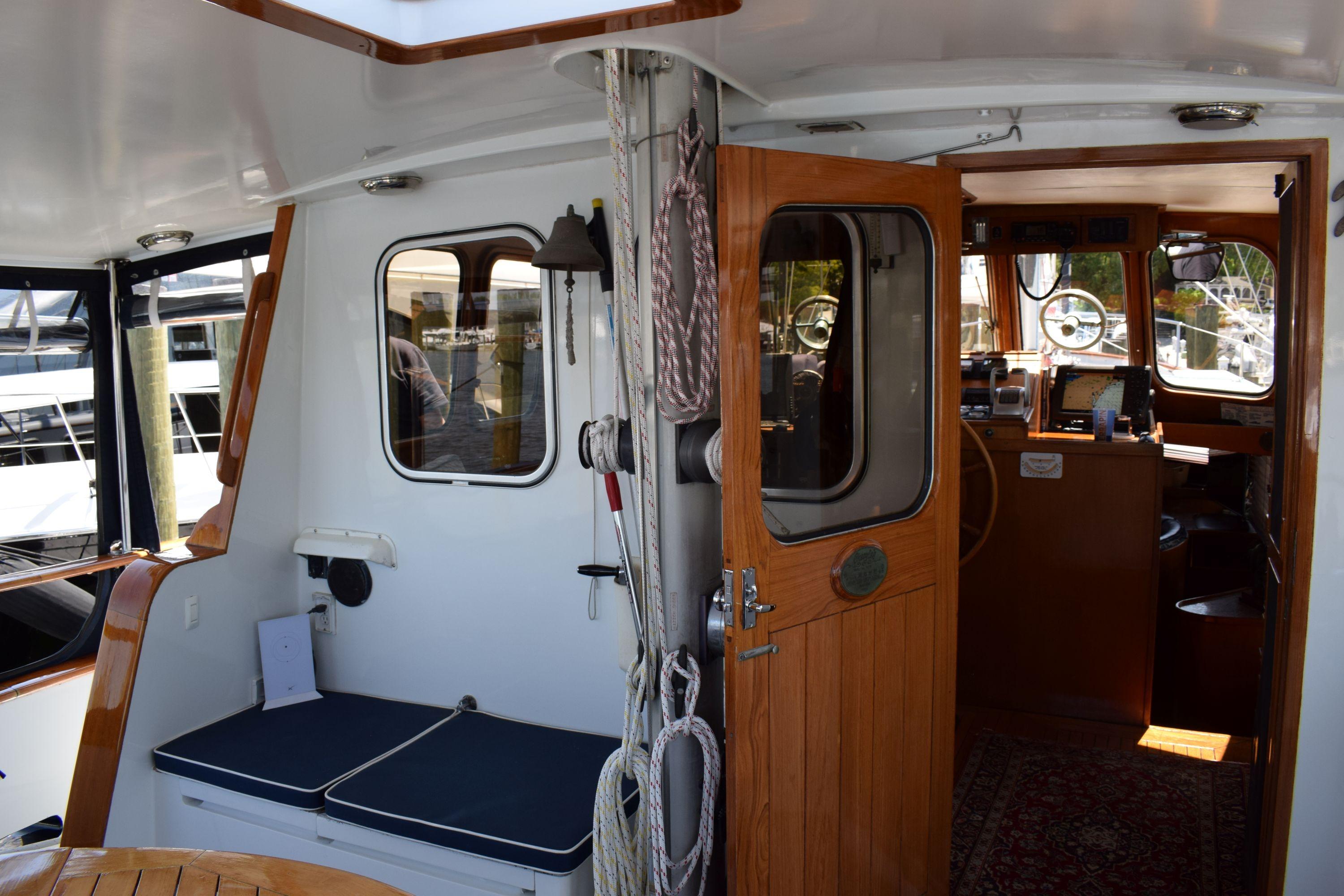 Interior view of 1980 Cheoy Lee 52 Motorsailer, featuring wooden door and nautical decor.