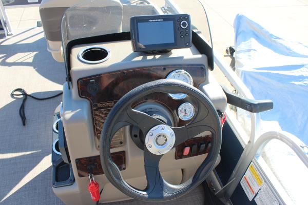 2024 Sun Tracker BB18 boat dashboard with steering wheel and navigation system.