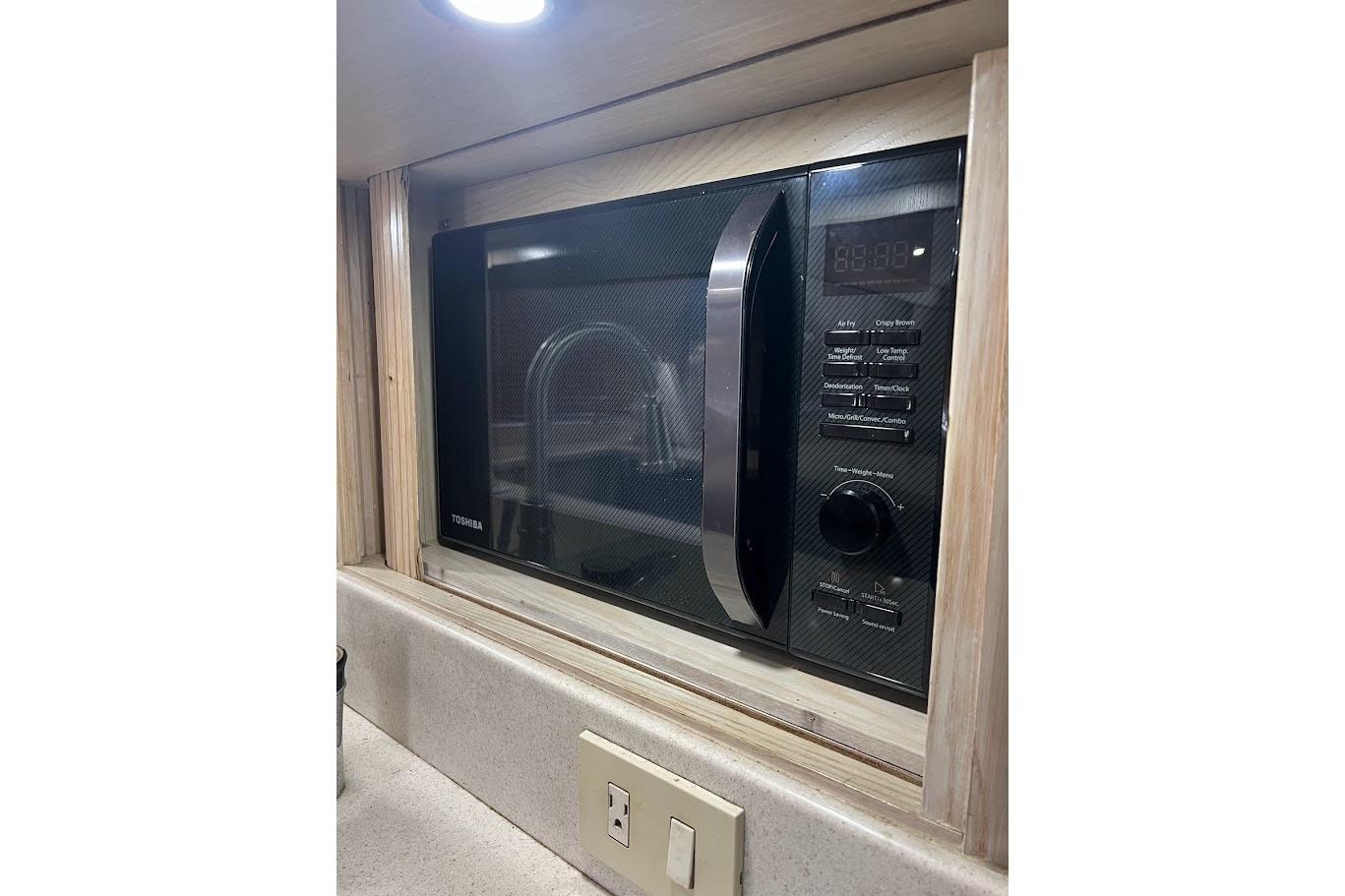 Built-in Toshiba microwave in 1996 Ocean Yachts 48 Super Sport kitchen area.