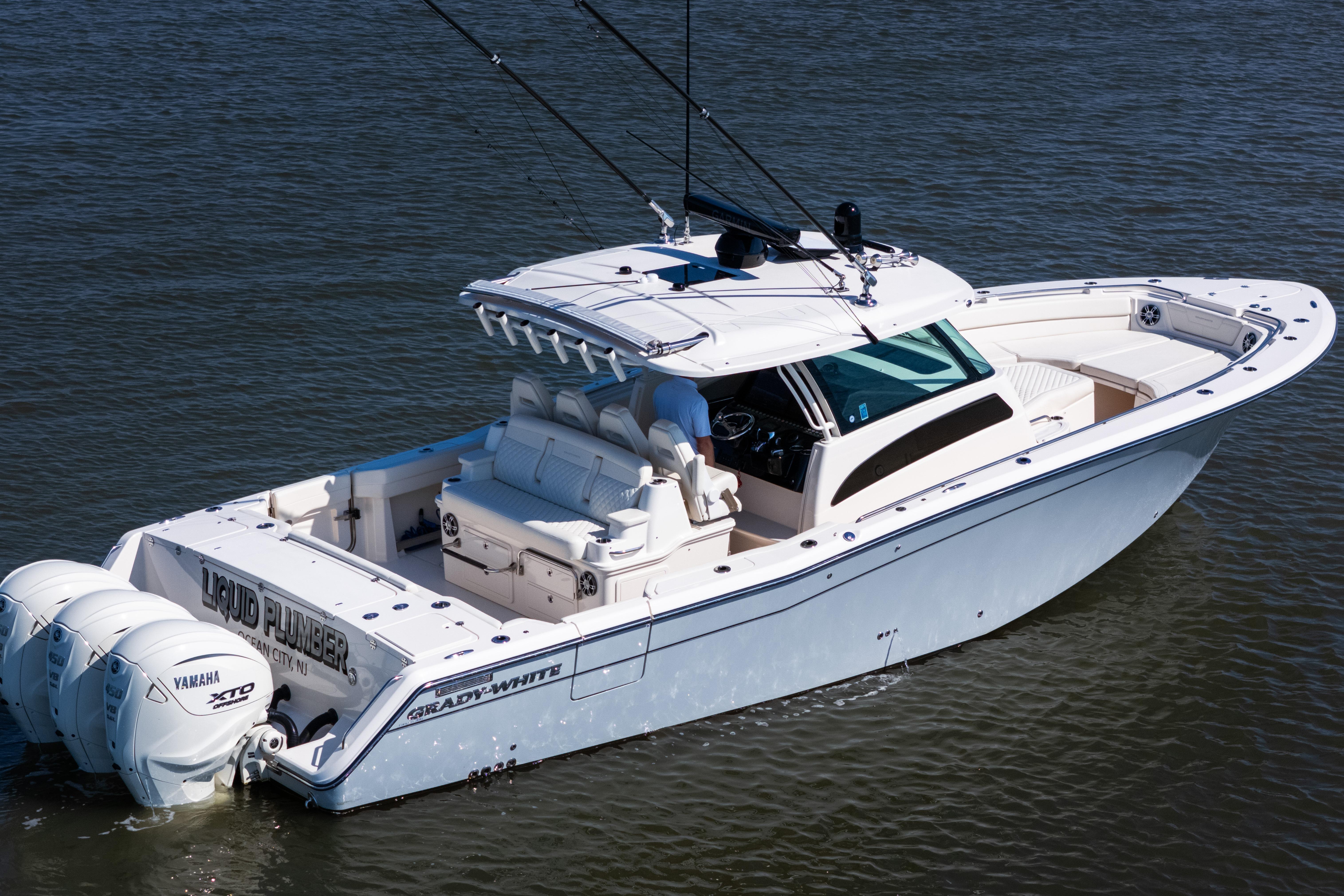 2025 Grady-White Canyon 386 boat on water, featuring triple Yamaha engines.