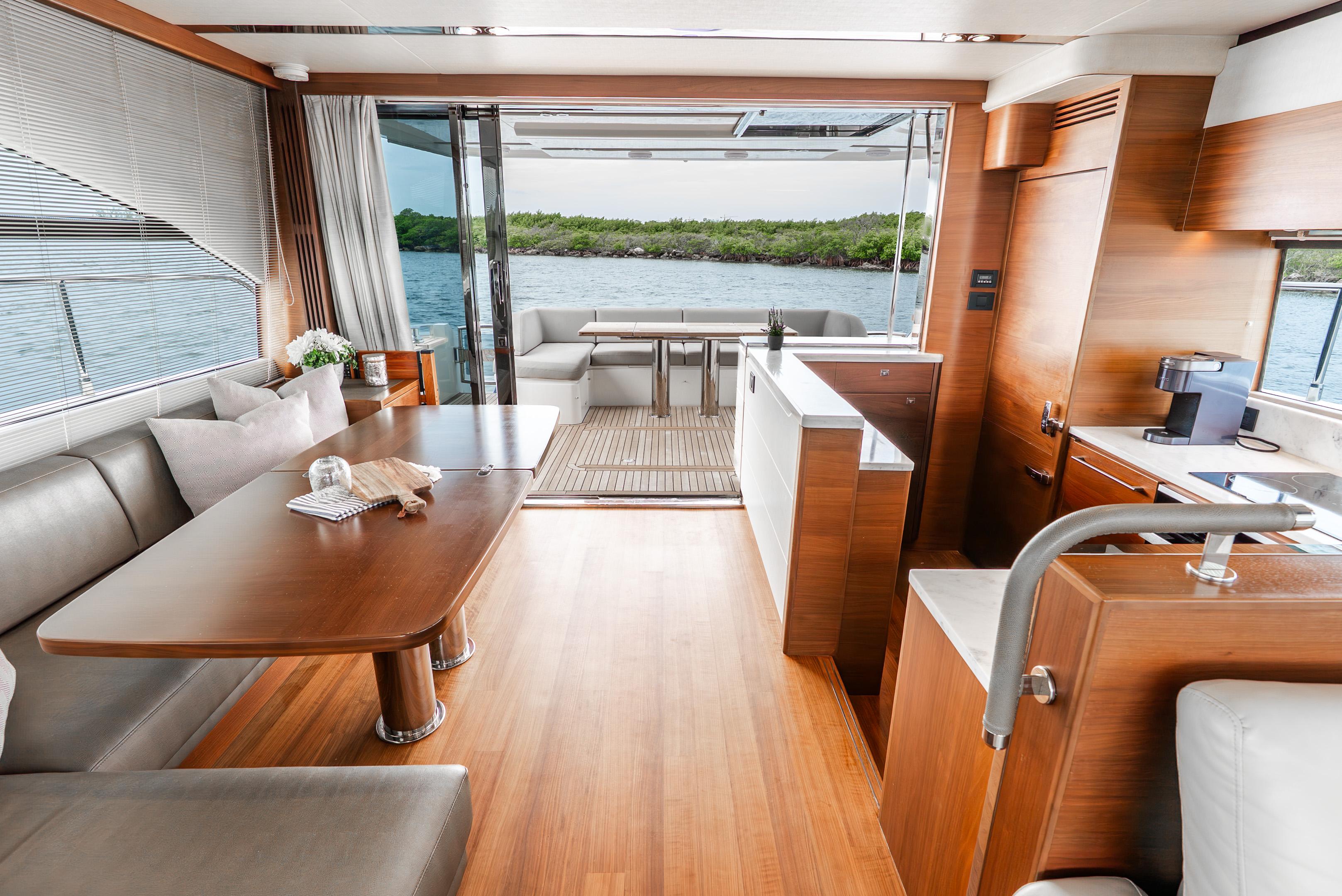 Luxurious interior of 2018 Princess F-68 yacht with elegant wood finishes and scenic water view.