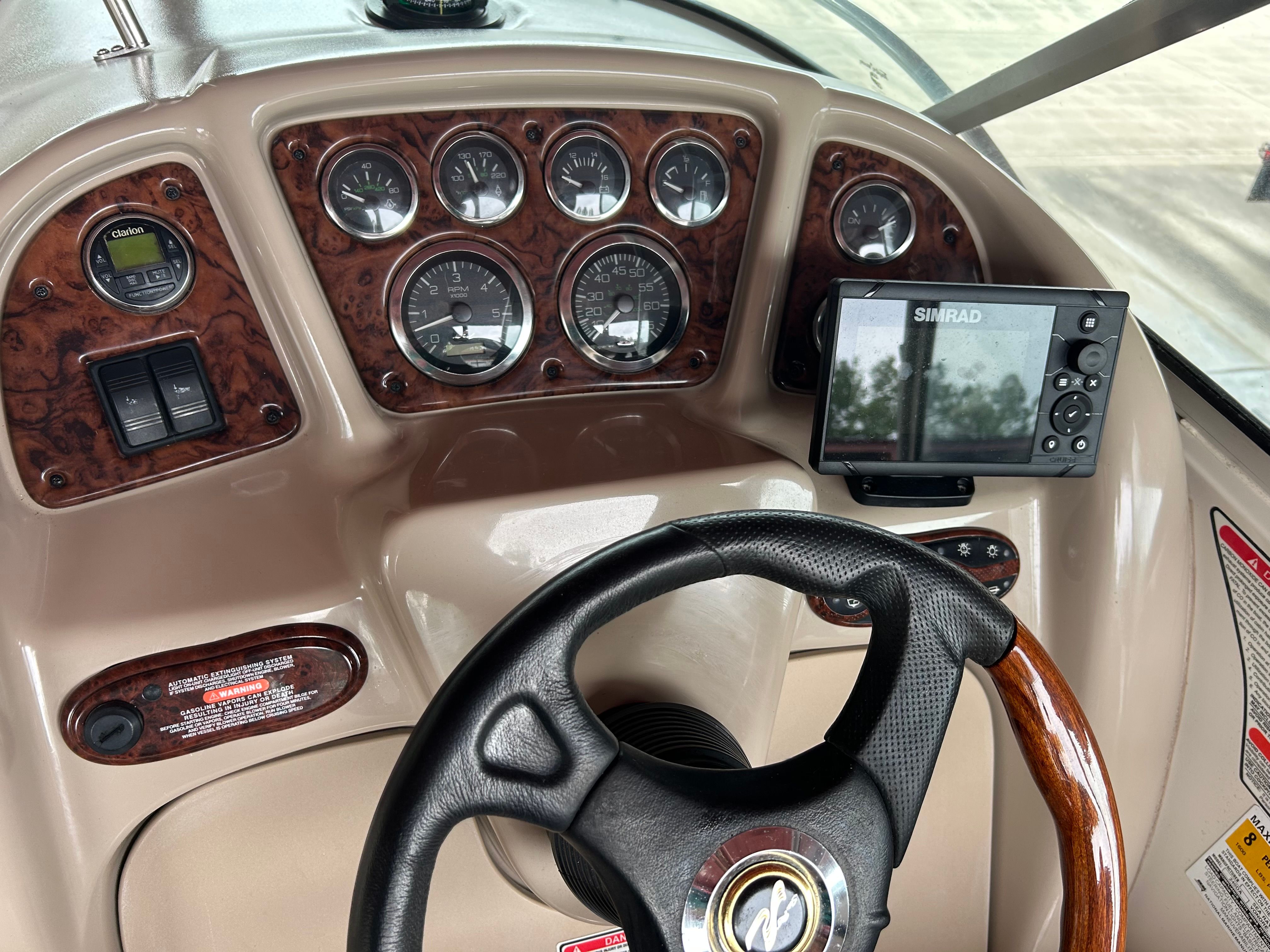Dashboard of 2003 Sea Ray 240 Sundancer with gauges and Simrad display.