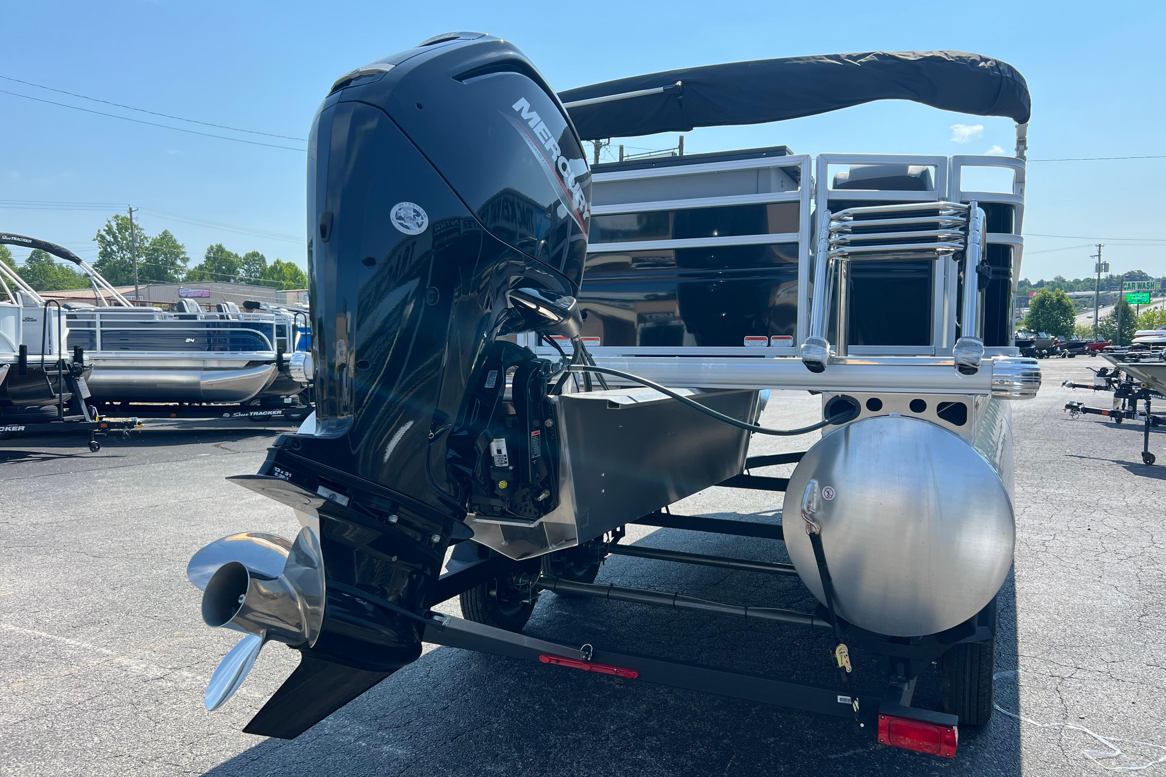 2026 Sun Tracker SportFish 20 DLX pontoon boat with powerful Mercury outboard motor.