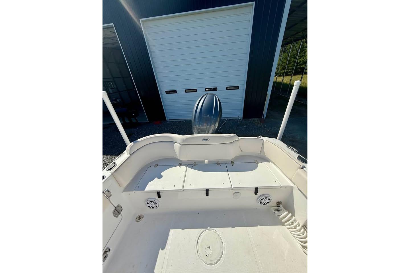2026 Sea Hunt Ultra 235 SE boat interior with storage compartments and speakers.