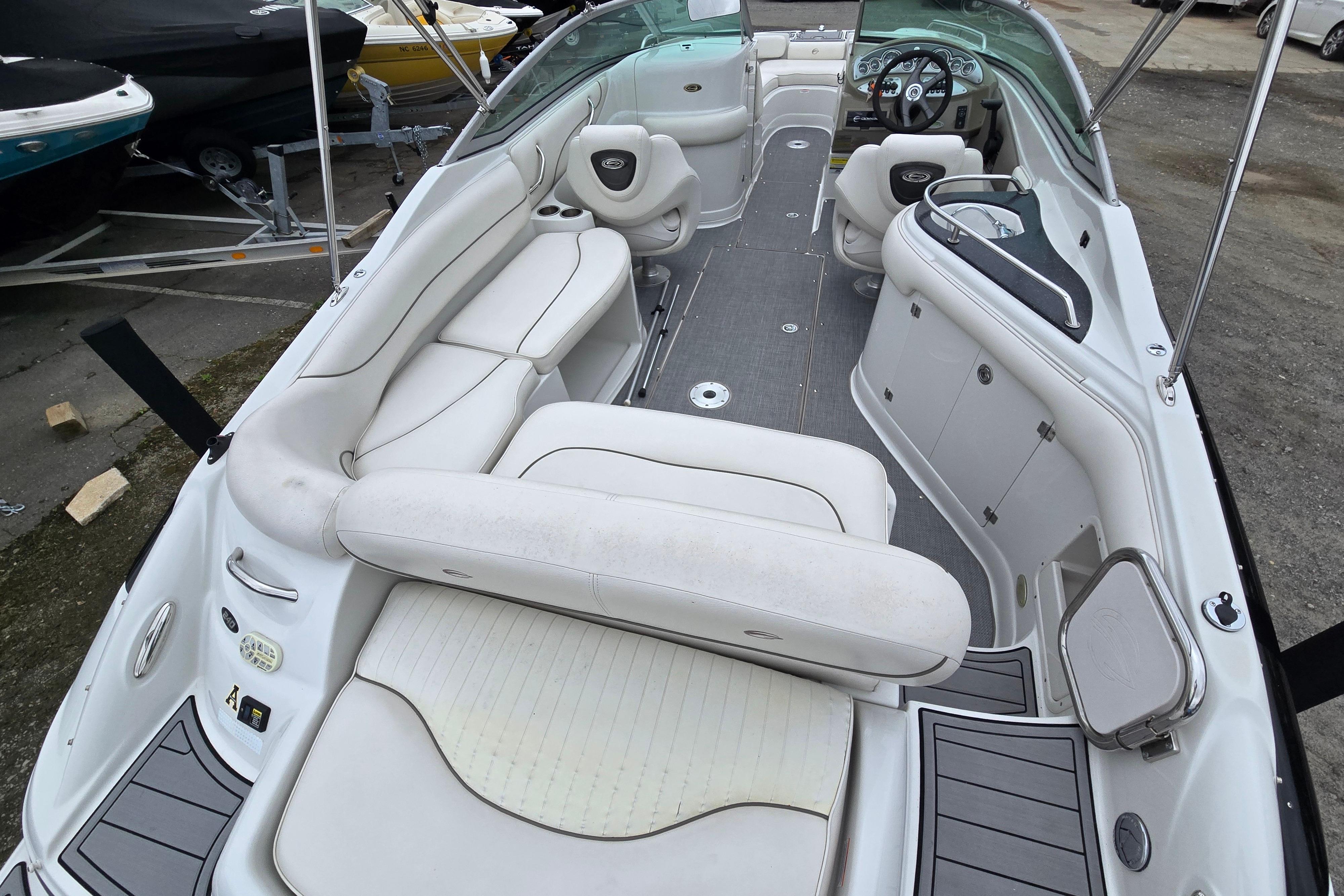 2006 Crownline 240 EX boat interior with white seating and steering wheel.