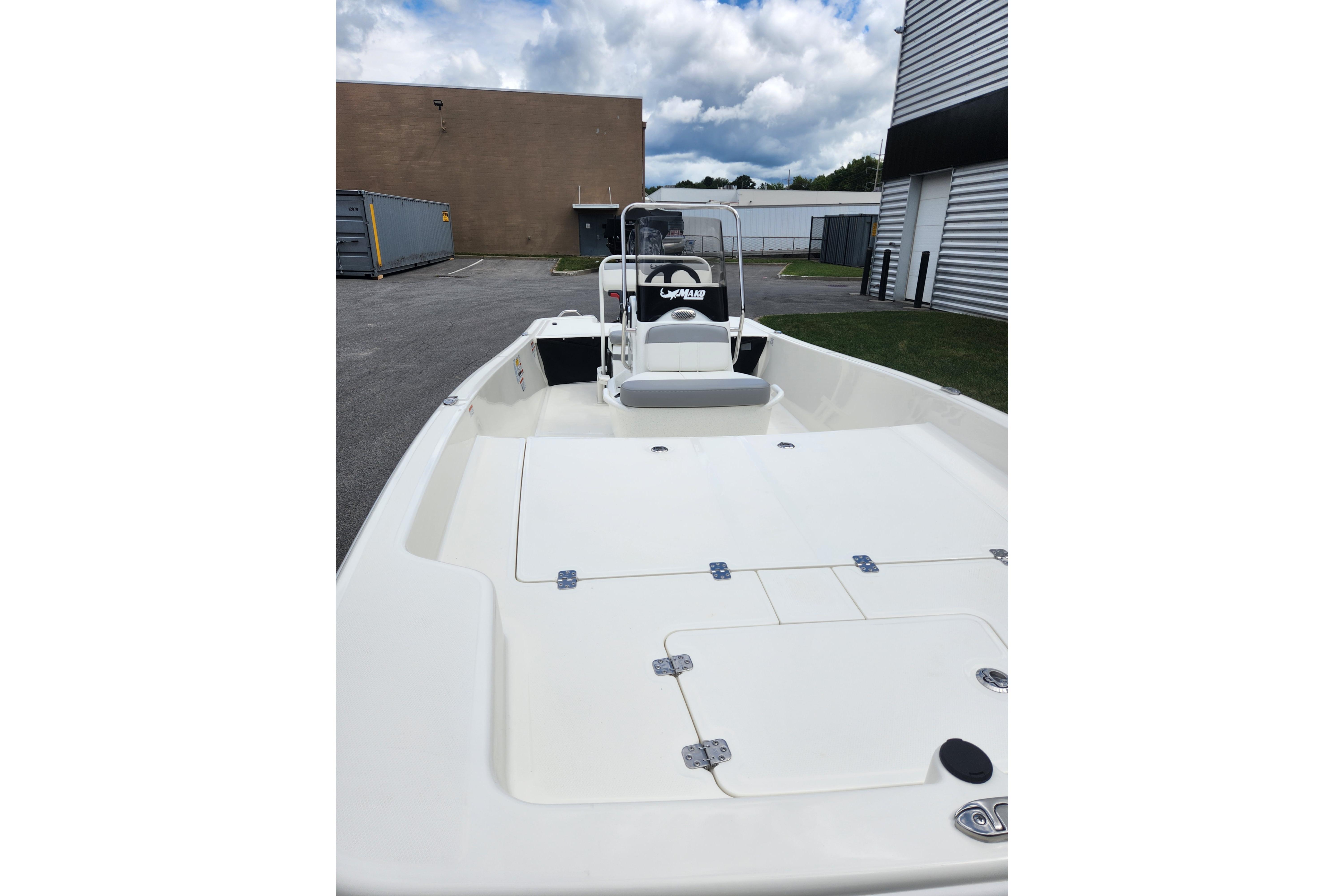 2026 Mako Pro Skiff 17 CC boat in a parking area, showcasing its spacious deck.