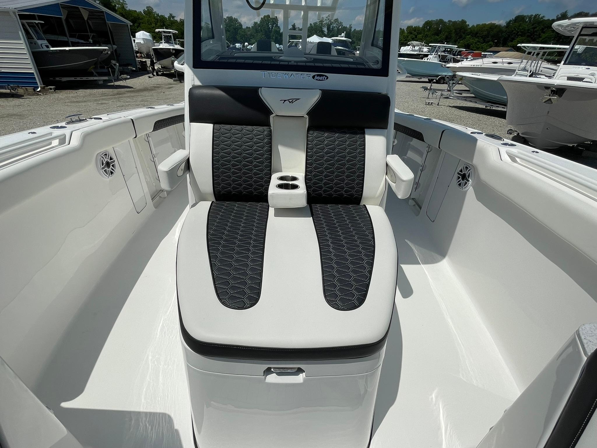 2026 Tidewater 302 CC Adventure boat interior with cushioned seating and cup holders.