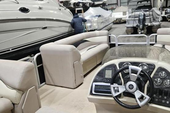 2013 Sweetwater SW 2286 pontoon boat interior with steering console and seating.