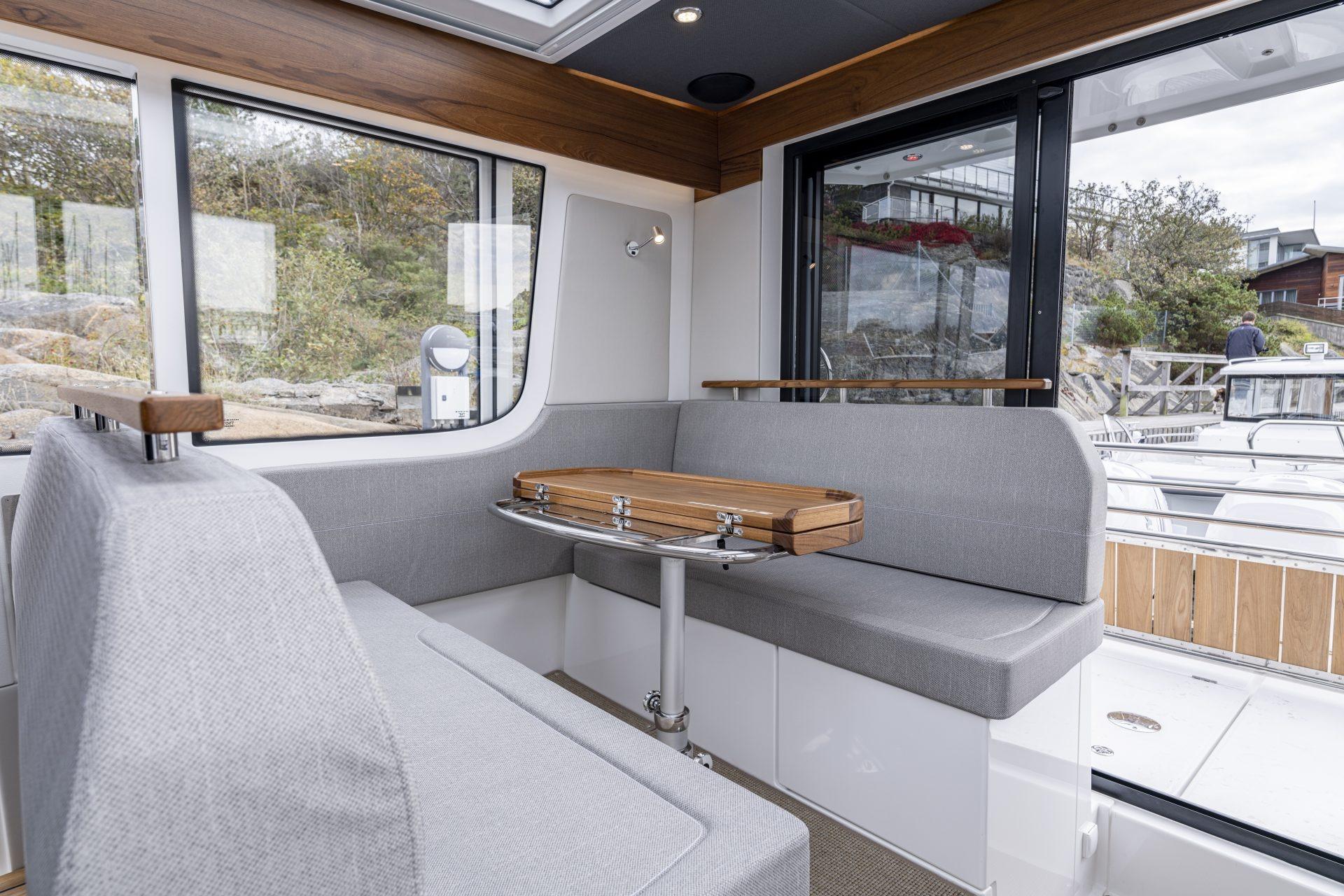Interior of Nimbus Commuter 11 boat, 2025 model, featuring gray seating.