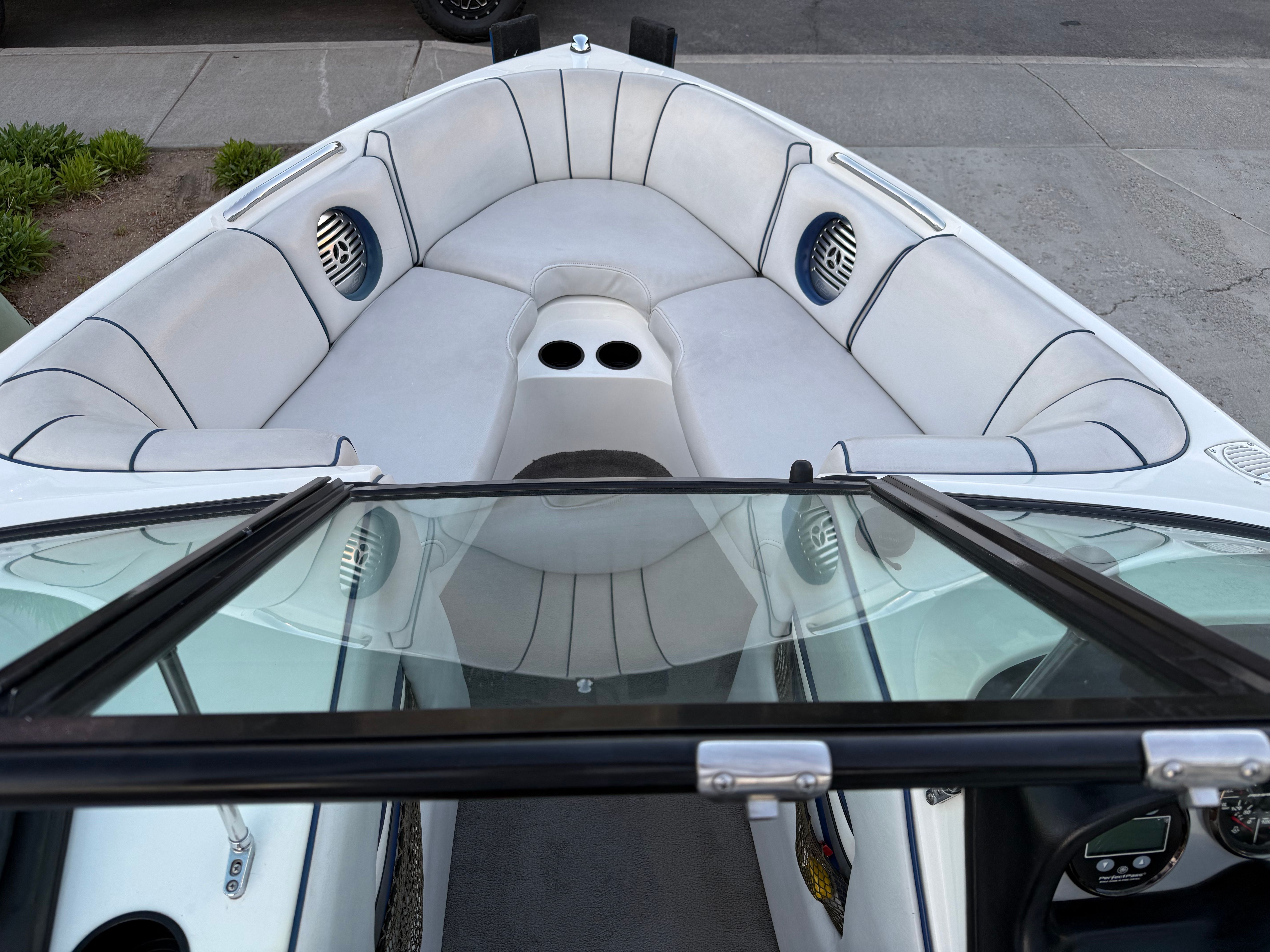 Interior of a 2004 MB Sports 220 boat with white seating.