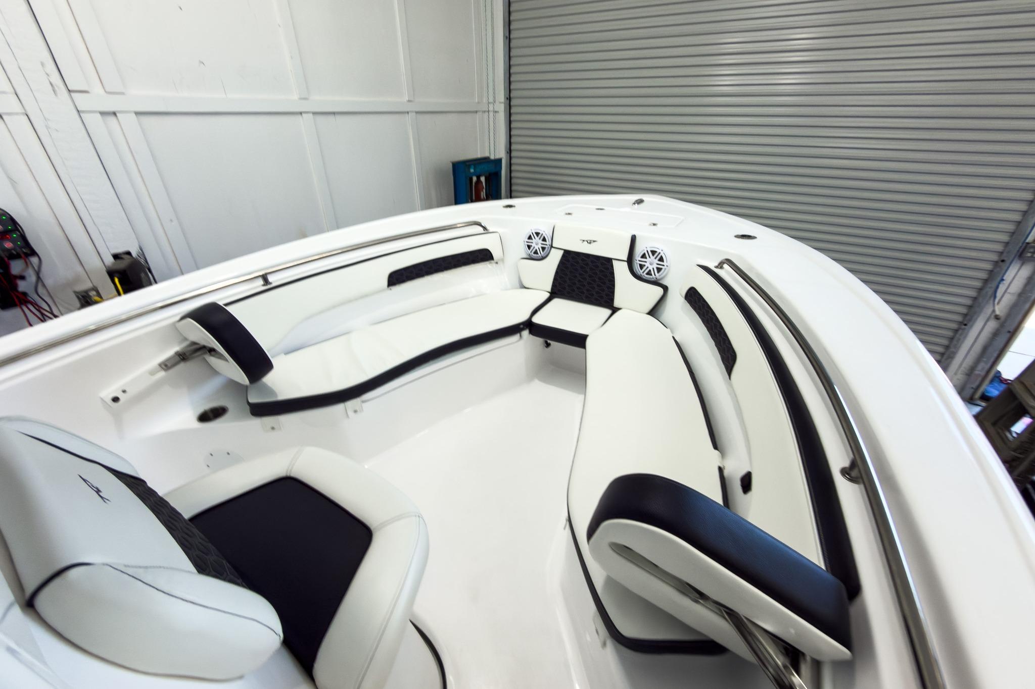 The image shows the interior of a Tidewater 220 LXF boat with white and black seating.