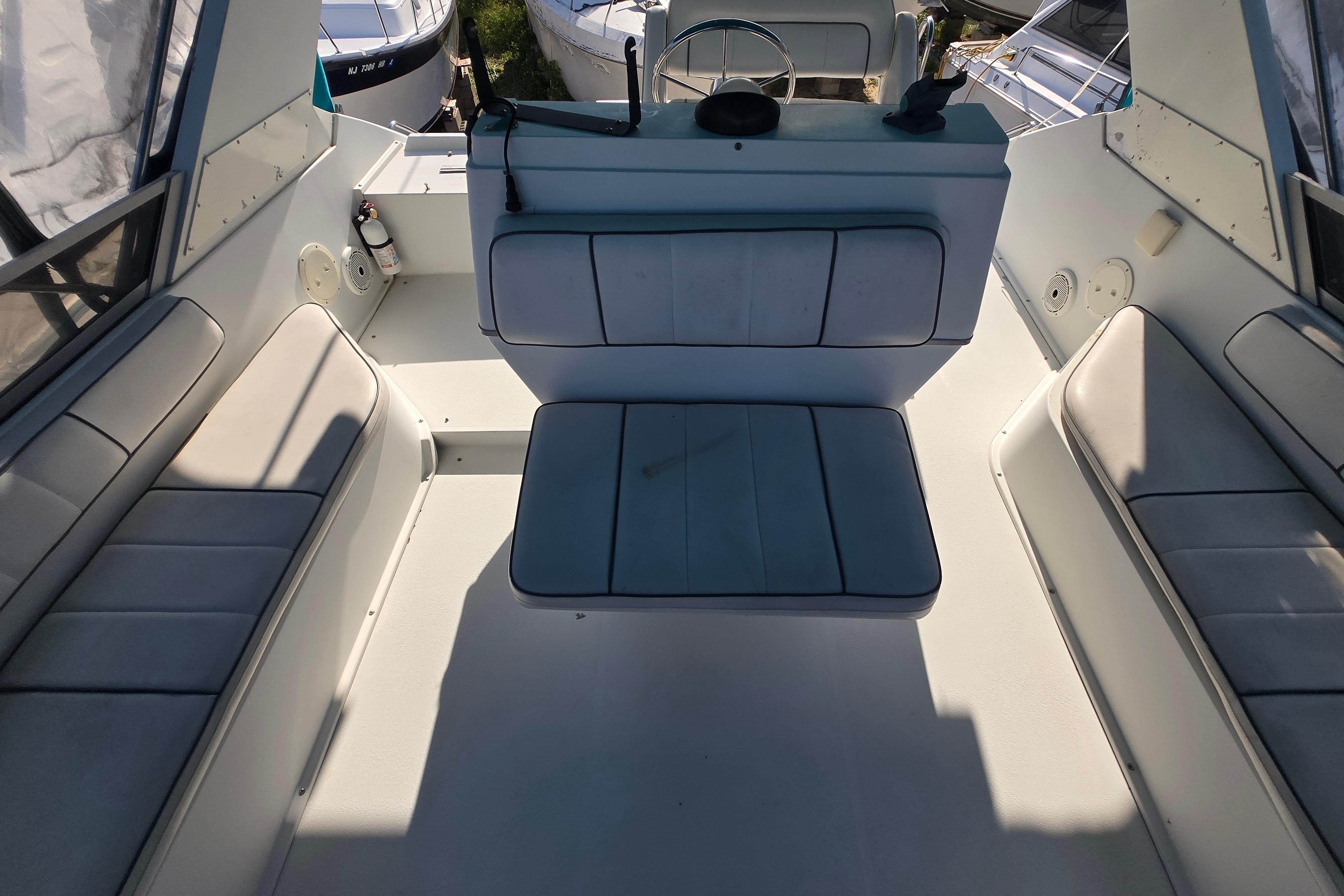 1994 Carver 380 Santego boat interior with cushioned seating and steering area.