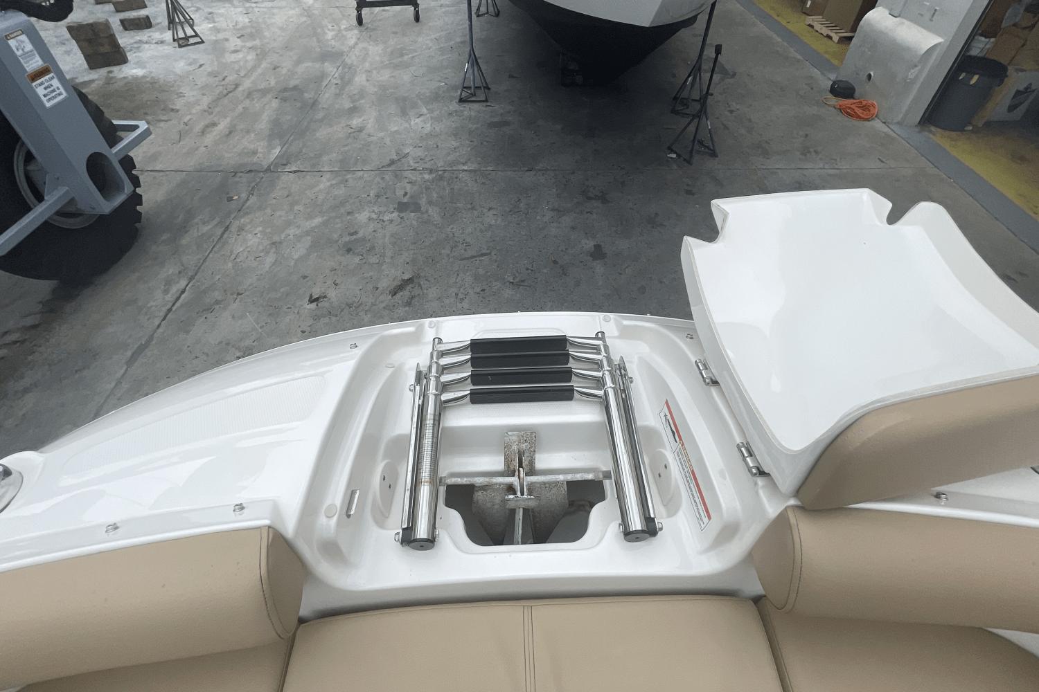 2019 Sea Ray SDX 250 Outboard boat with folded swim ladder on deck.