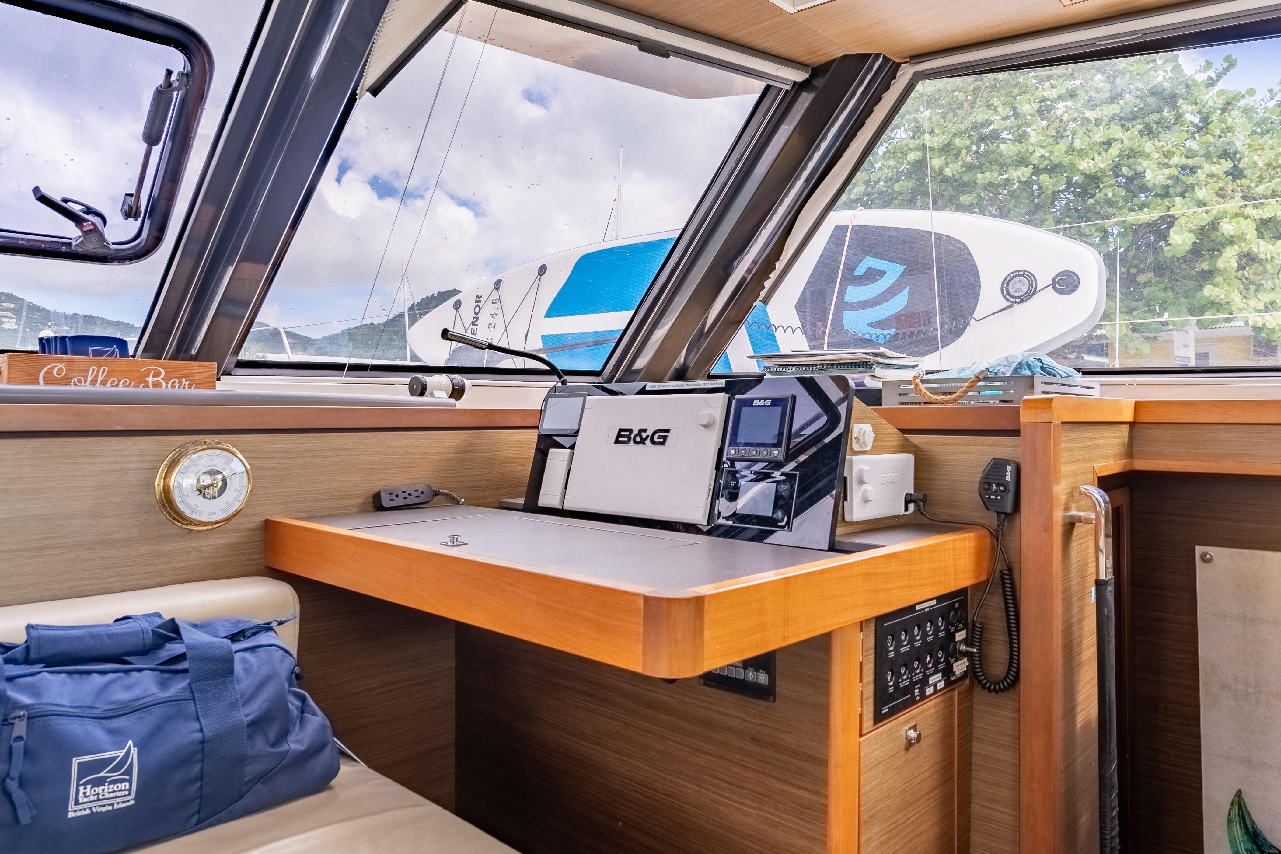 Interior of 2020 Nautitech 46 Fly yacht with navigation equipment and scenic window view.