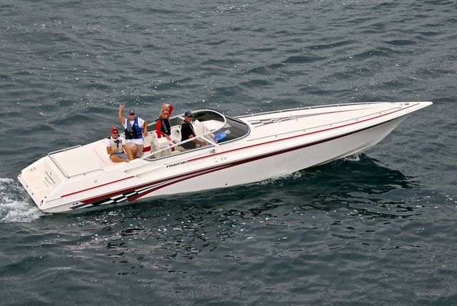 2001 Fountain Lightning boat on water with passengers.