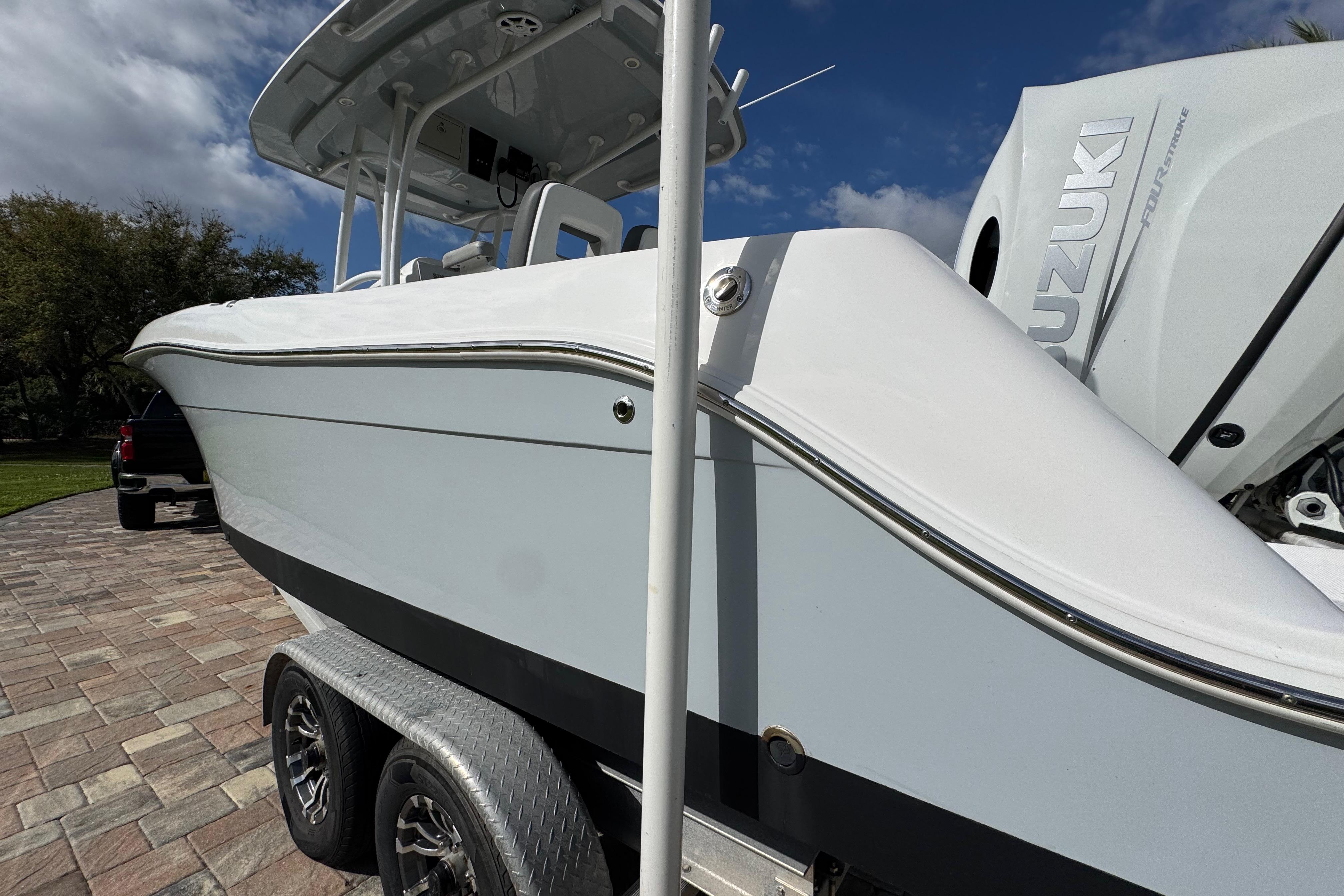 2022 Aquasport 2500 Center Console boat on trailer, featuring Suzuki outboard motor.