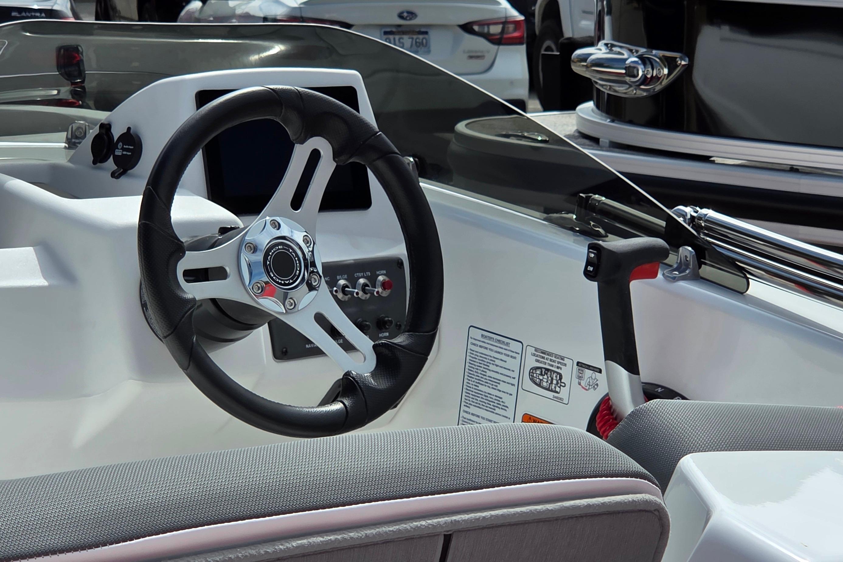 2026 Tahoe T18 boat interior with steering wheel and control panel.