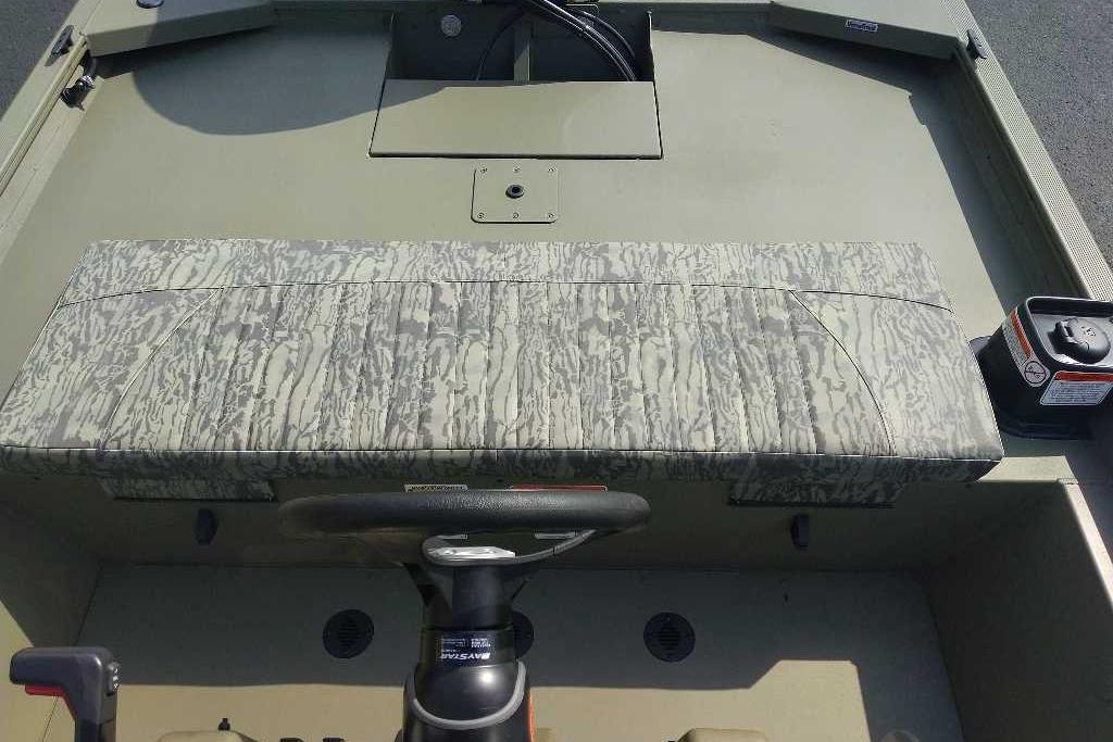 2026 Tracker Grizzly 1860 CC boat interior with camouflage seating and steering console.