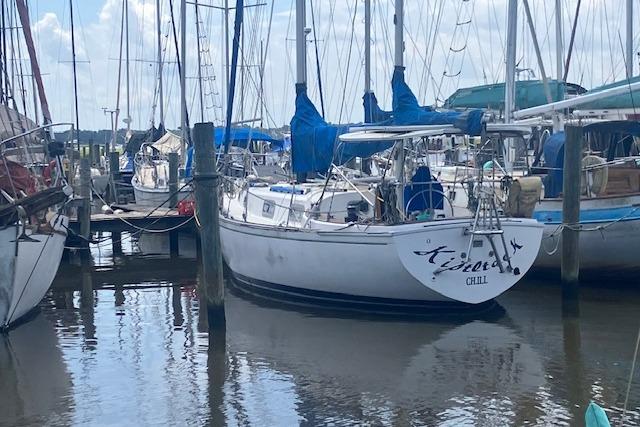 1979 Pearson 365 Ketch sailboat docked in marina, surrounded by other boats.