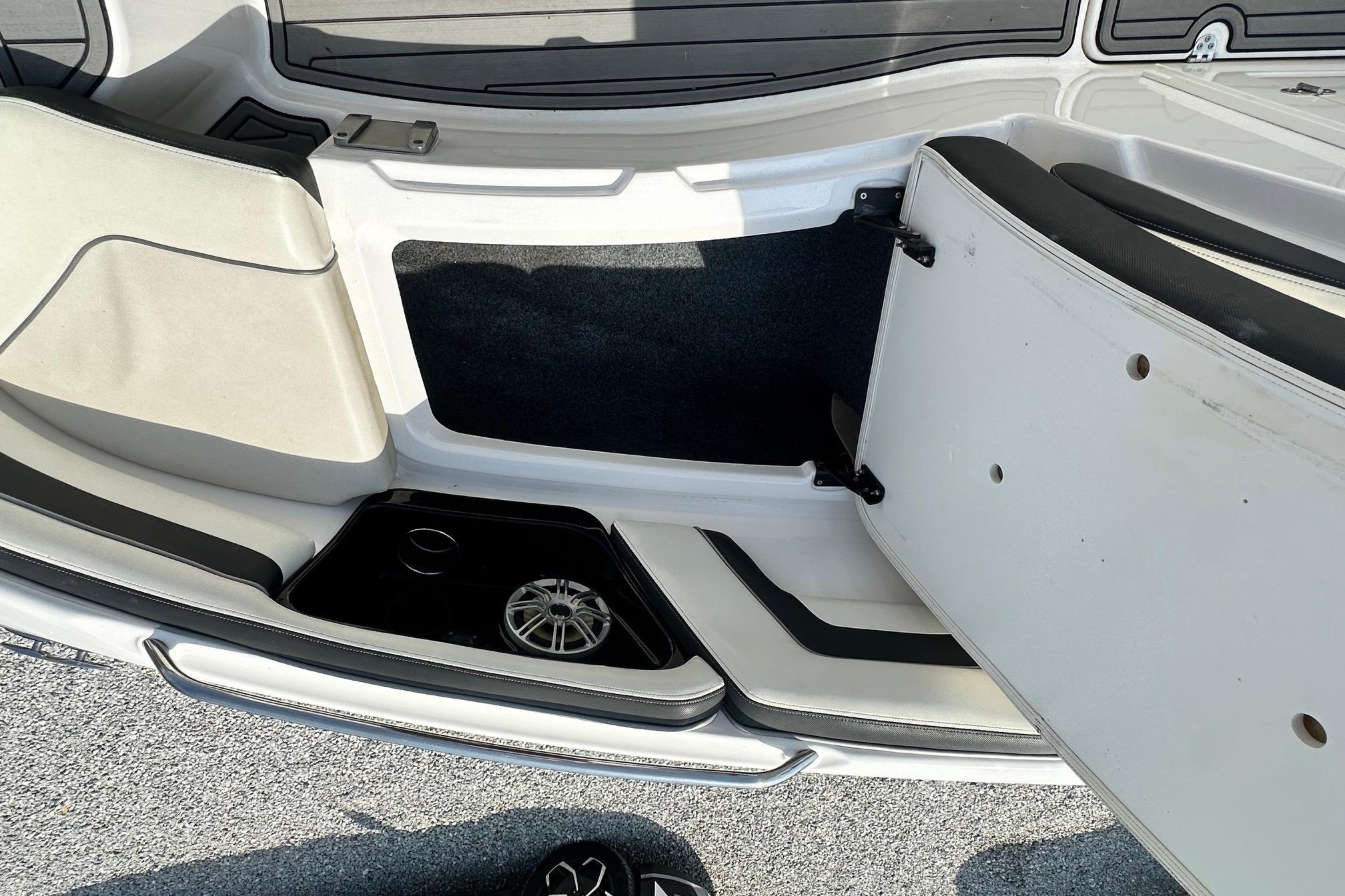 Interior view of a 2016 Yamaha 242 Limited S boat, showcasing seating and storage area.