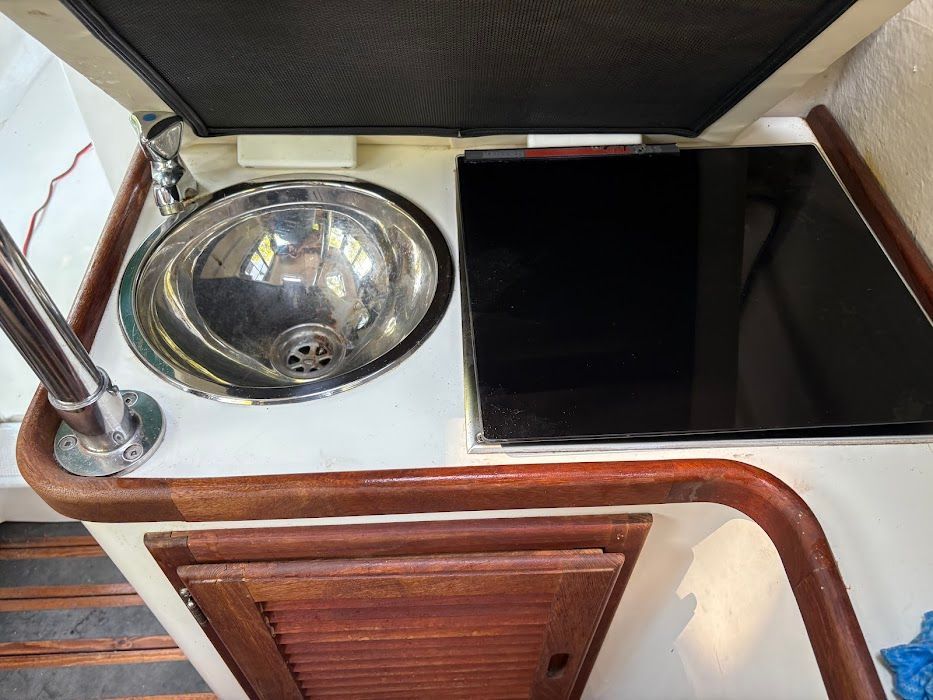 The galley of a 2007 Ranger Tugs R-21 EC with a sink and stovetop.