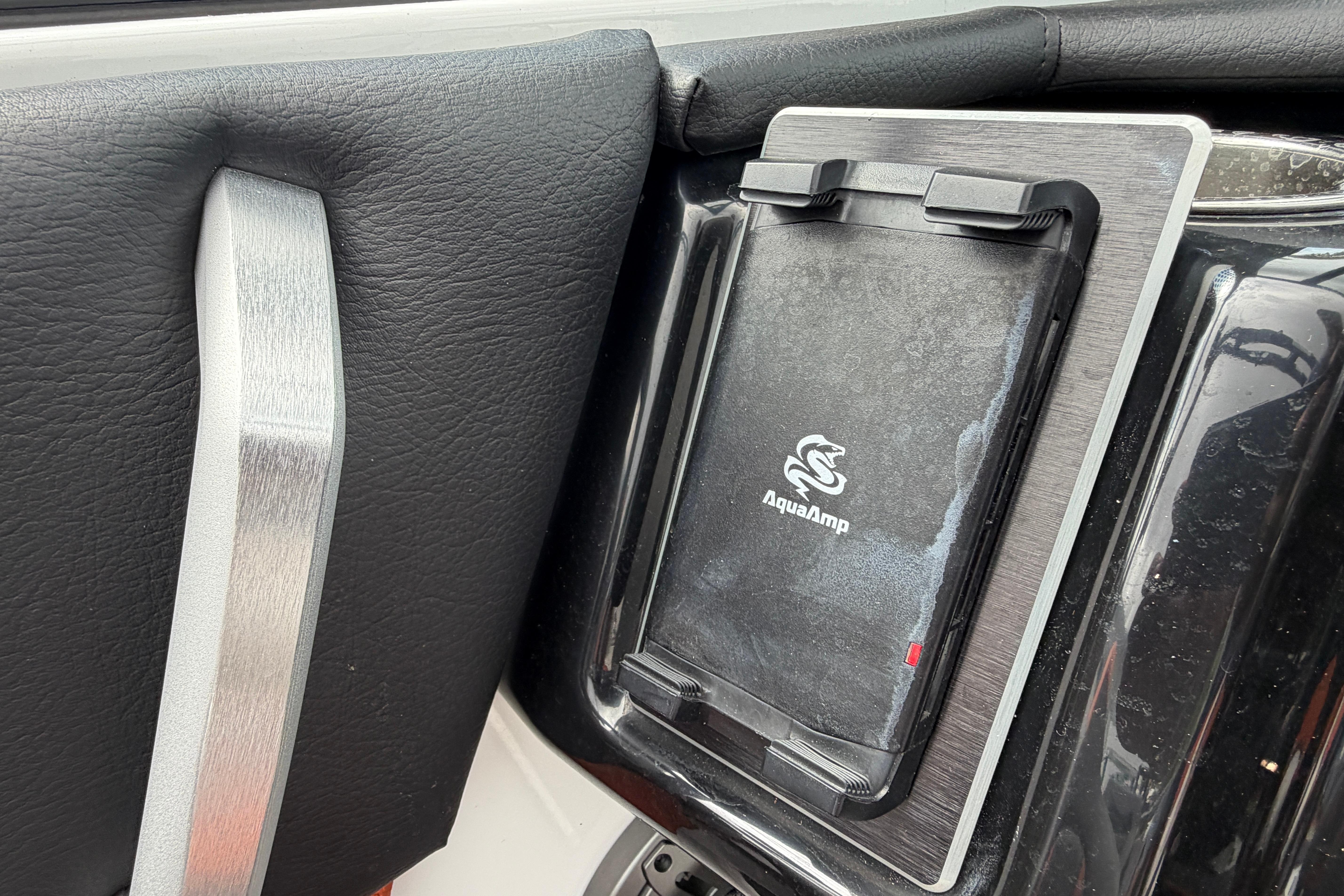 AquaAmp device in 2026 Scarab 235 LX boat interior, featuring sleek black and silver design.
