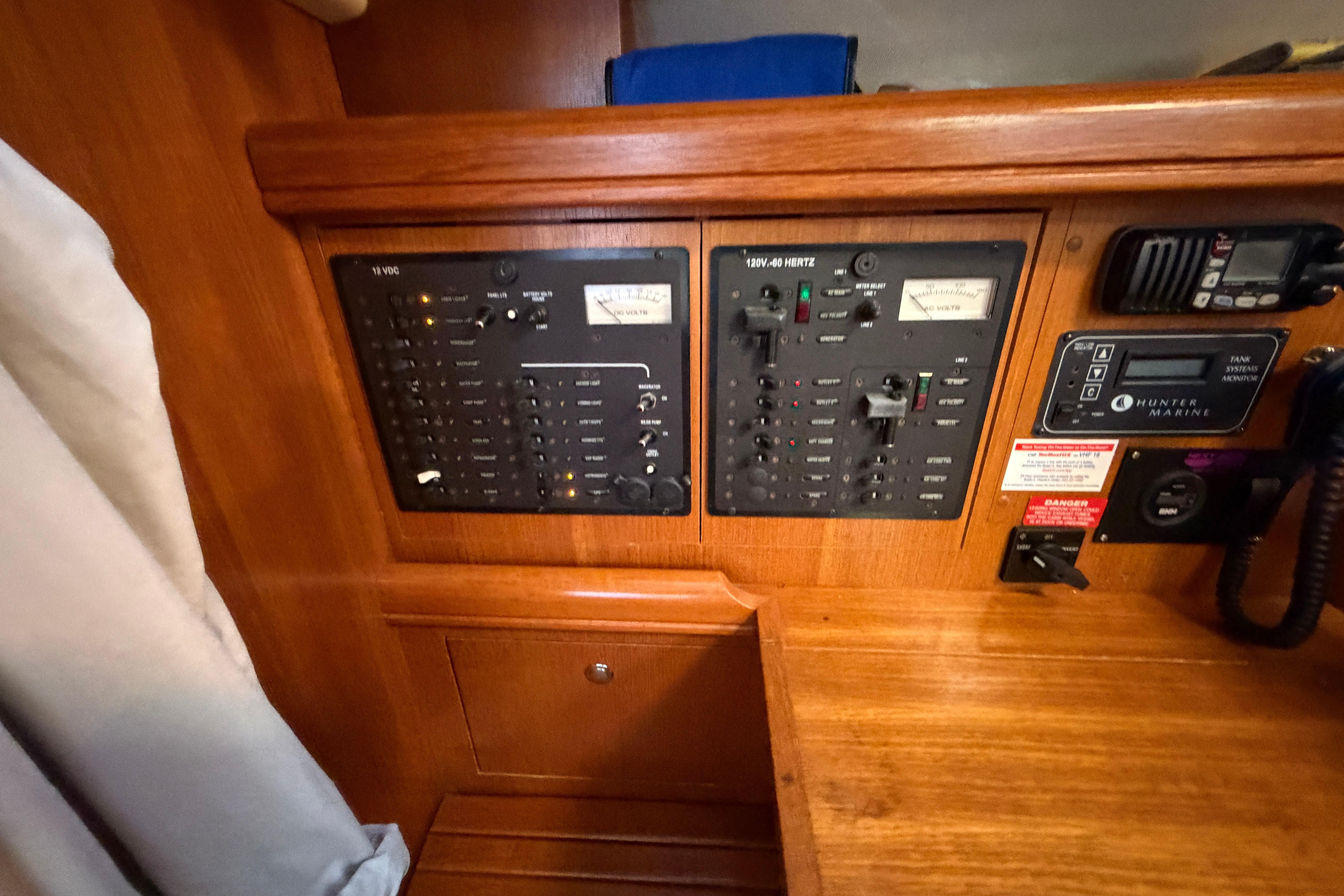 Electrical control panel on a 2005 Hunter 38 sailboat, featuring various switches and gauges.