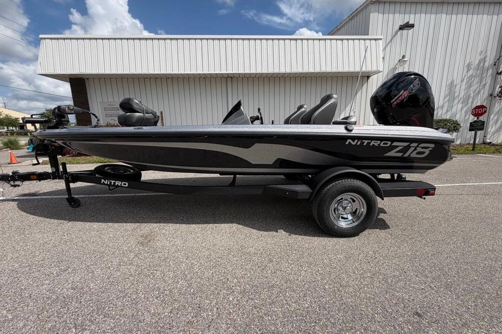 2026 Nitro Z18 boat on trailer, parked outdoors near a white building.