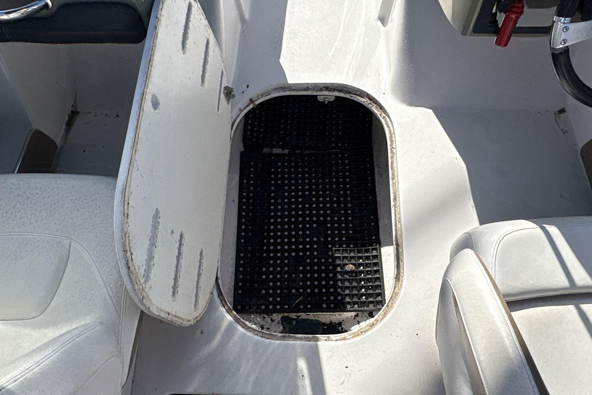 Open storage compartment on 2007 Four Winns 200 Horizon boat interior.