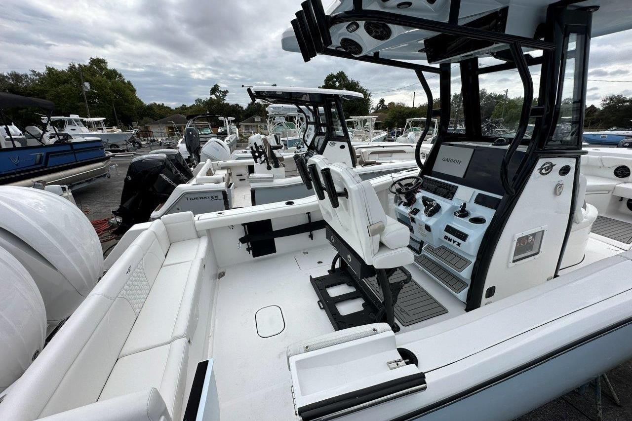 2026 Tidewater 272 LXF boat interior with modern helm and seating, docked under cloudy skies.