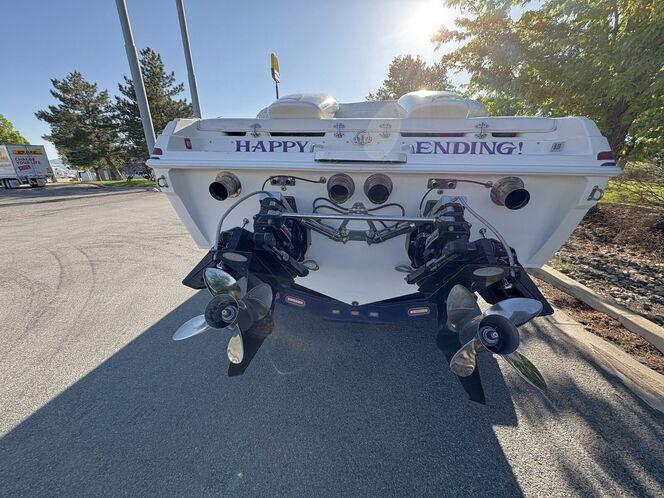 Rear view of 2002 Advantage Victory boat with dual propellers and "Happy Ending" text.