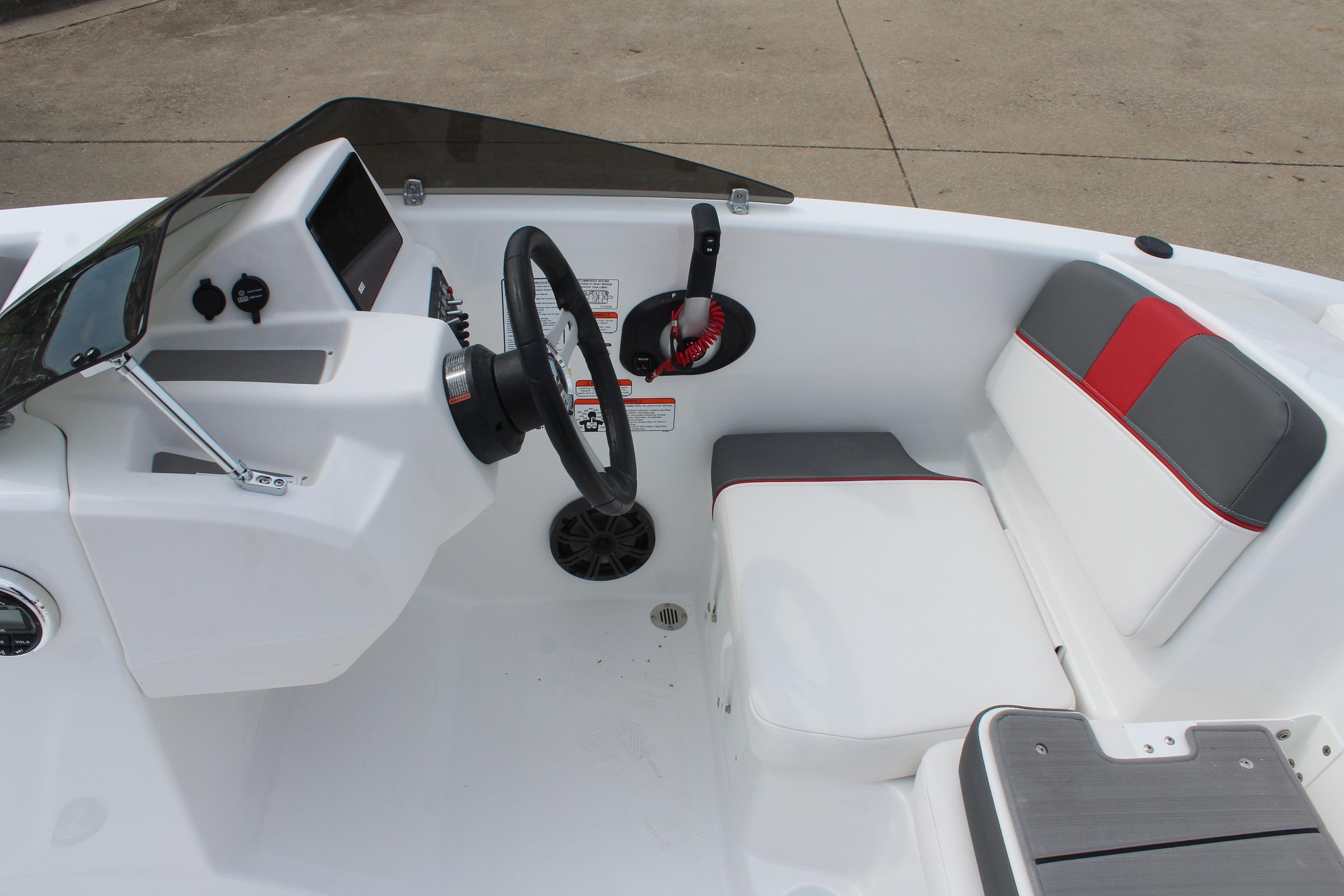Interior of 2026 Tahoe T16 boat with steering wheel and seating.