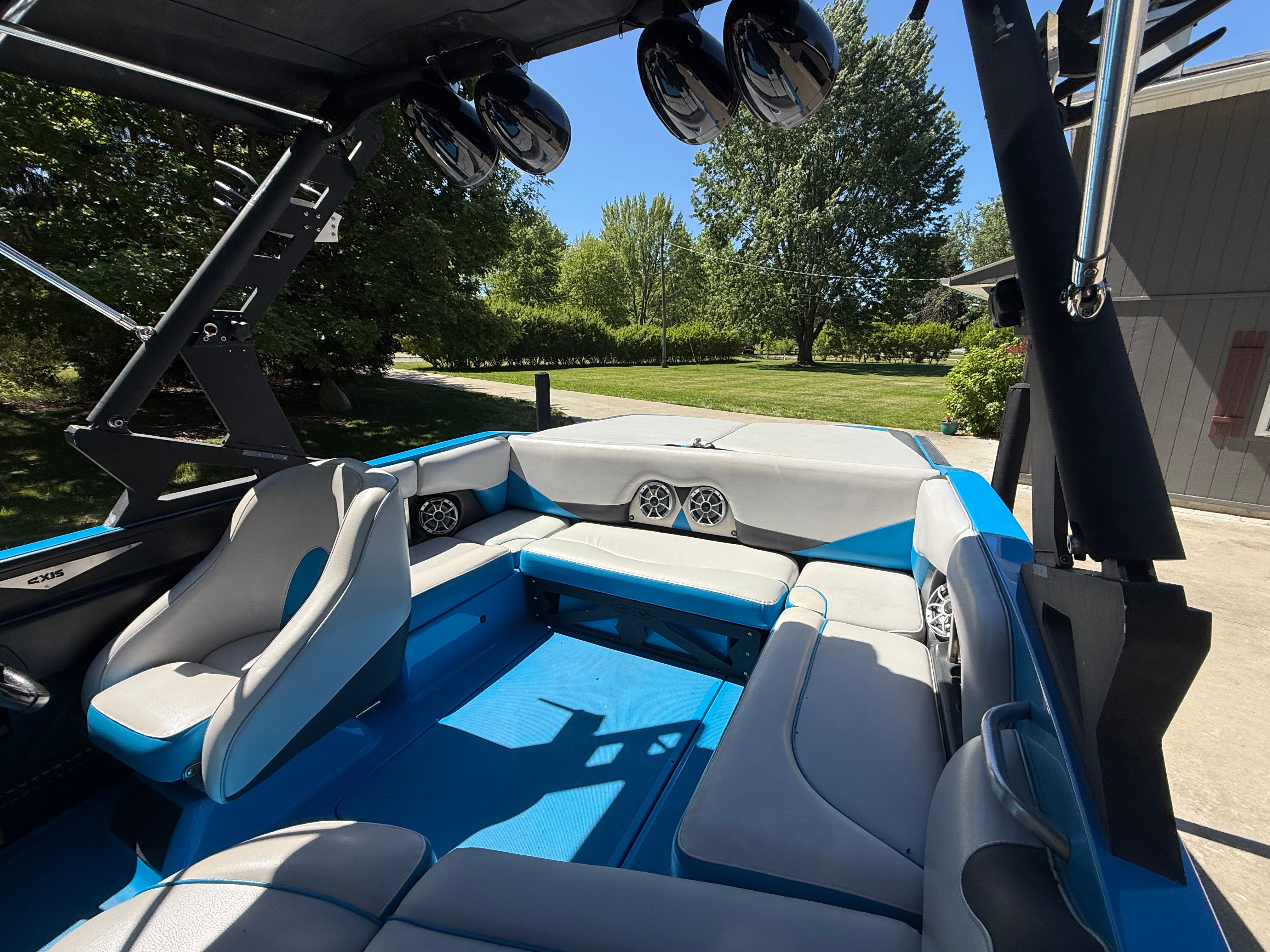 Interior of a 2015 Malibu Axis A20 boat with blue and gray seating.