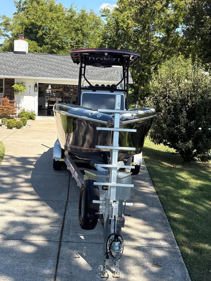 2012 Donzi 35 ZF Open boat on trailer in driveway.