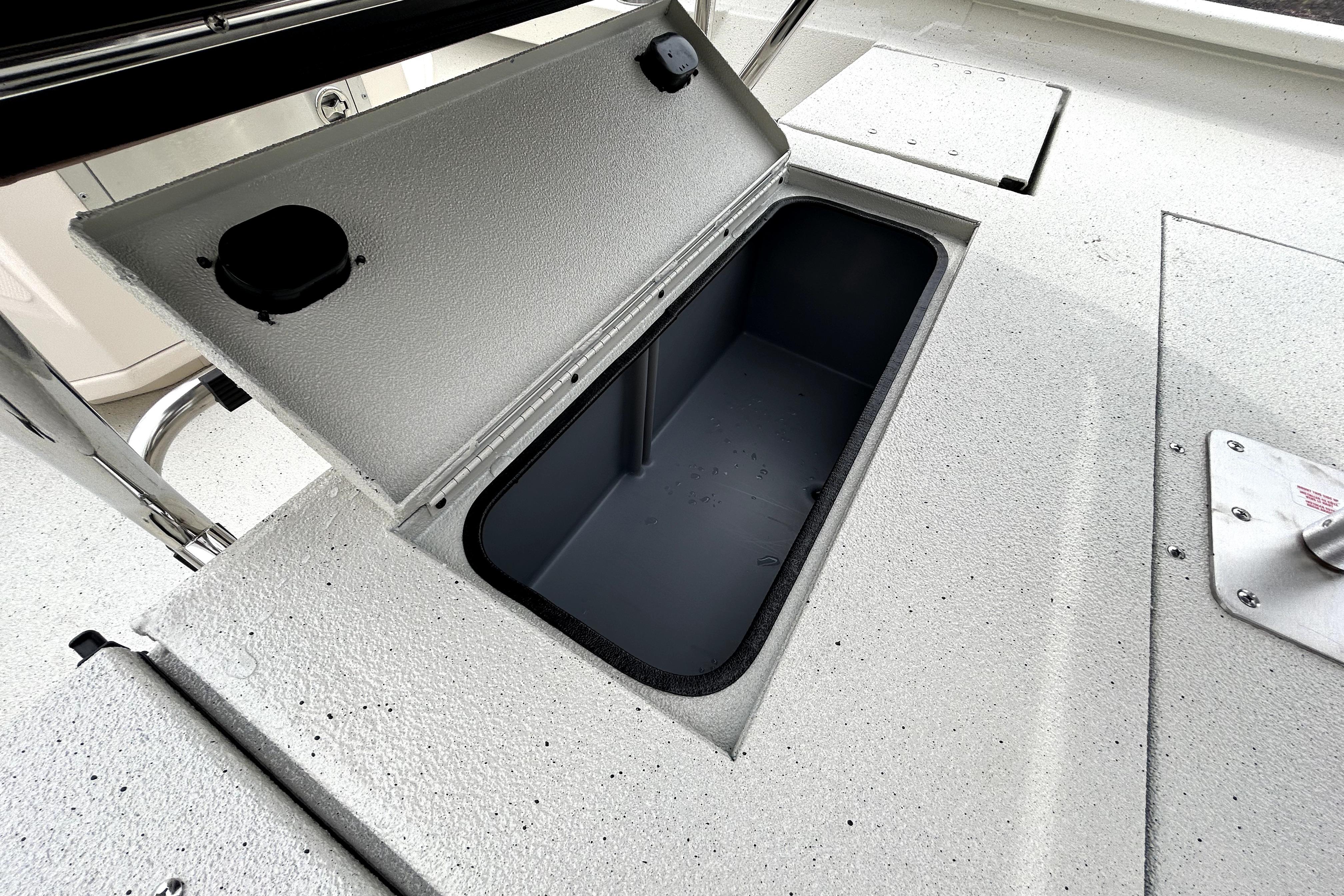 Open storage compartment on 2026 Xpress H20B Bay boat deck.