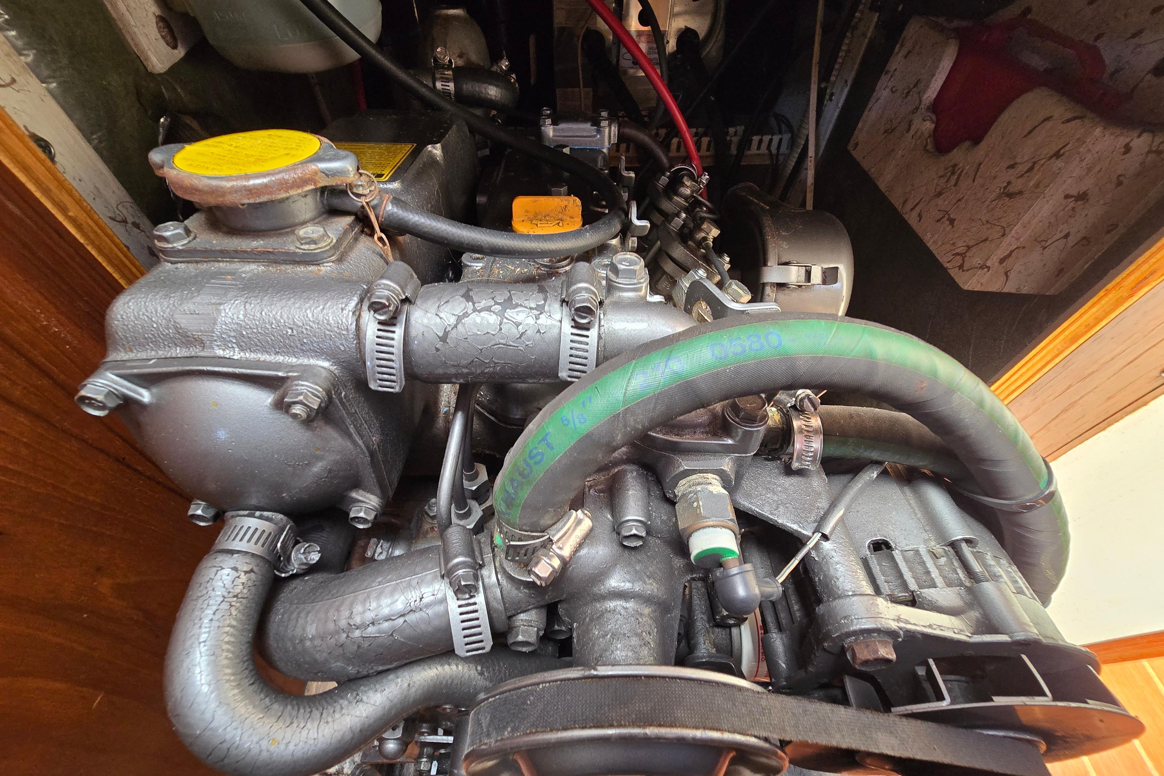 Close-up of a 1993 Caliber 35 engine with visible hoses and components.