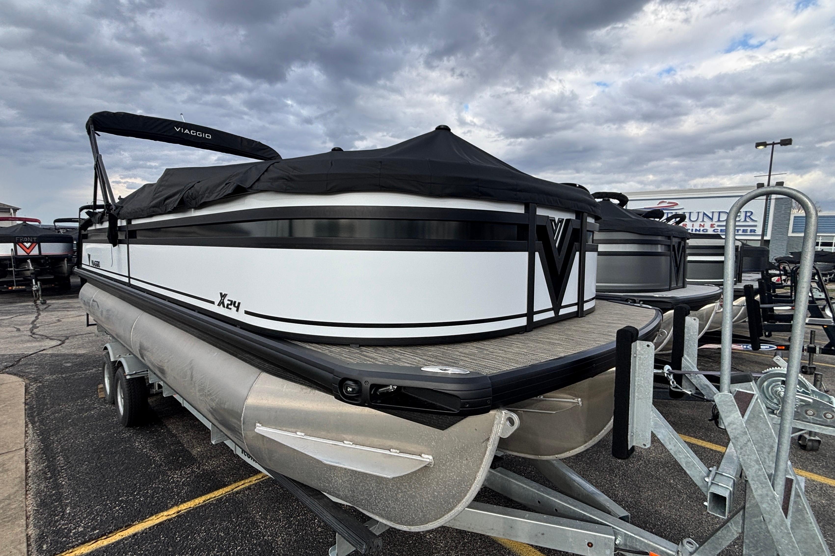 2026 Viaggio Lago X24U pontoon boat on trailer under cloudy sky.