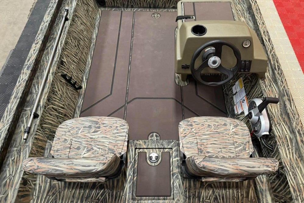 2026 Tracker Grizzly 1754 SC All-Welded boat interior with camo seats and steering console.