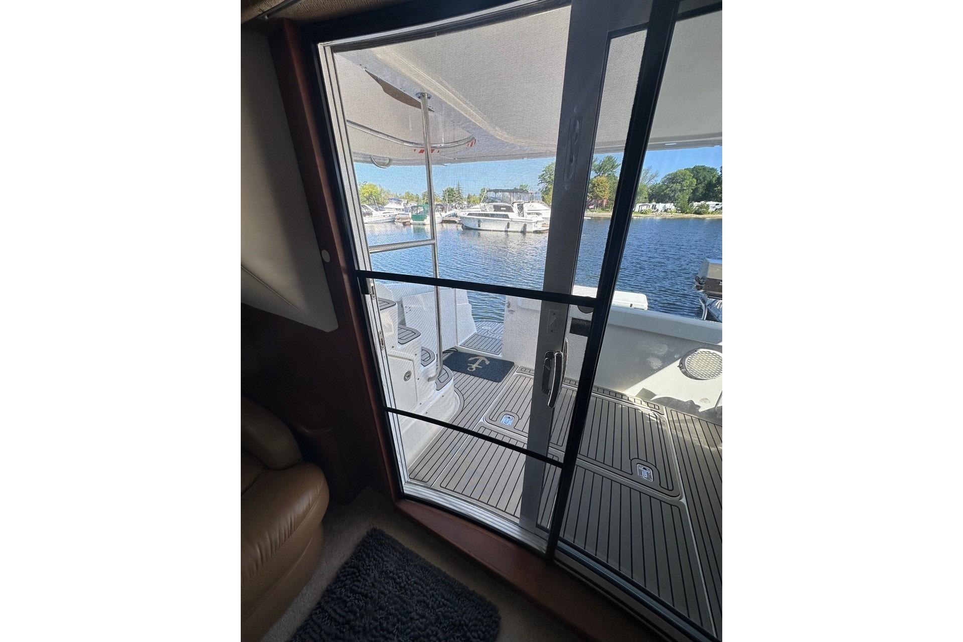2005 Silverton 38 Sport Bridge yacht interior view through sliding glass door to deck.