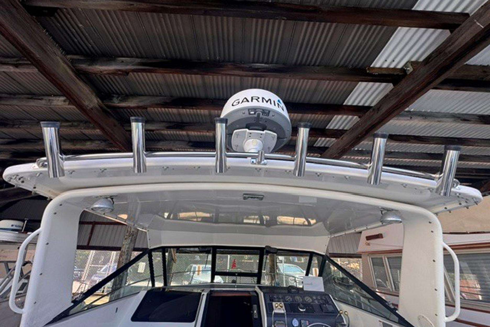 1988 Tiara Yachts 3300 Open with Garmin radar, docked under a metal roof.